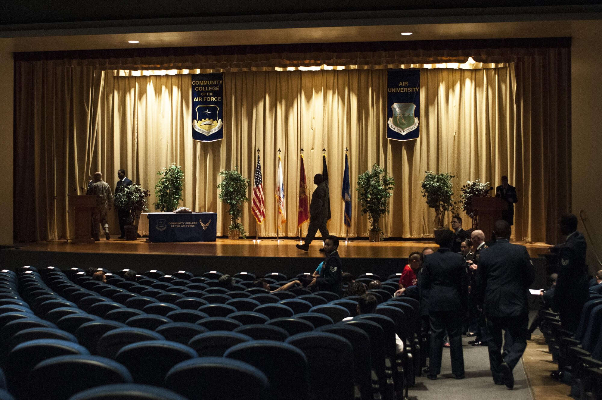 Airman, soldiers and seaman prepare for the Community College of the Air Force ceremony at the base theater on Goodfellow Air Force Base, Texas, May 8, 2015. Some Goodfellow members received their second CCAF degree. (U.S. Air Force photo by Senior Airman Scott Jackson)