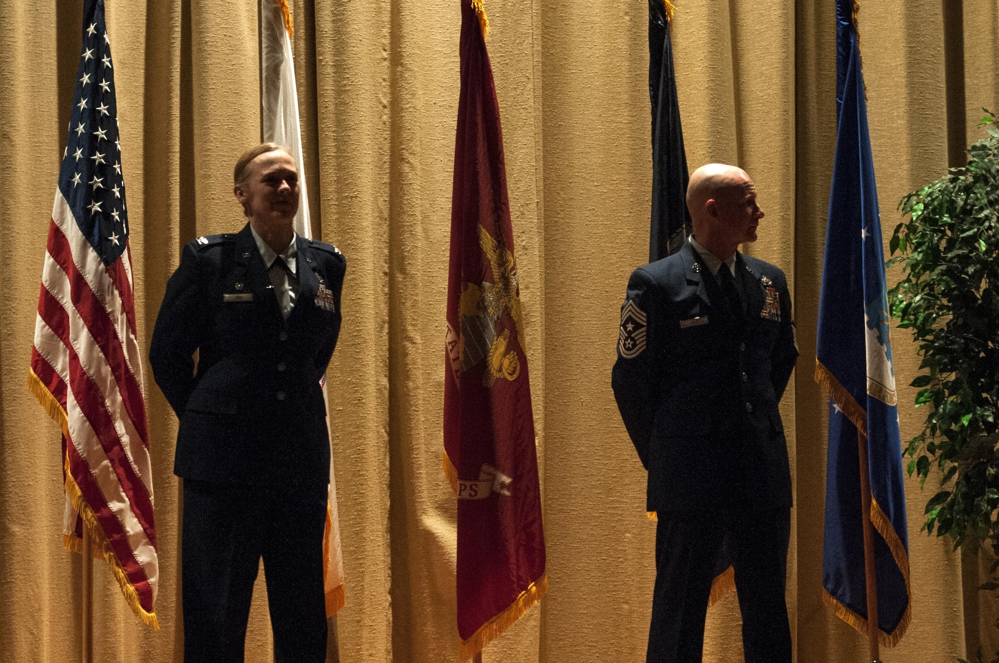 U.S. Air Force Col. Kimberly P. Joos, 17th Training Wing Commander, and Chief Master Sgt. Thomas F. Good, 17th Training Wing Command Chief, await the announcement of the Air Force graduates during the Community College of the Air Force graduation ceremony at the base theater on Goodfellow Air Force Base, Texas, May 8, 2015. Some Goodfellow members received their second CCAF degree. (U.S. Air Force photo by Senior Airman Scott Jackson)