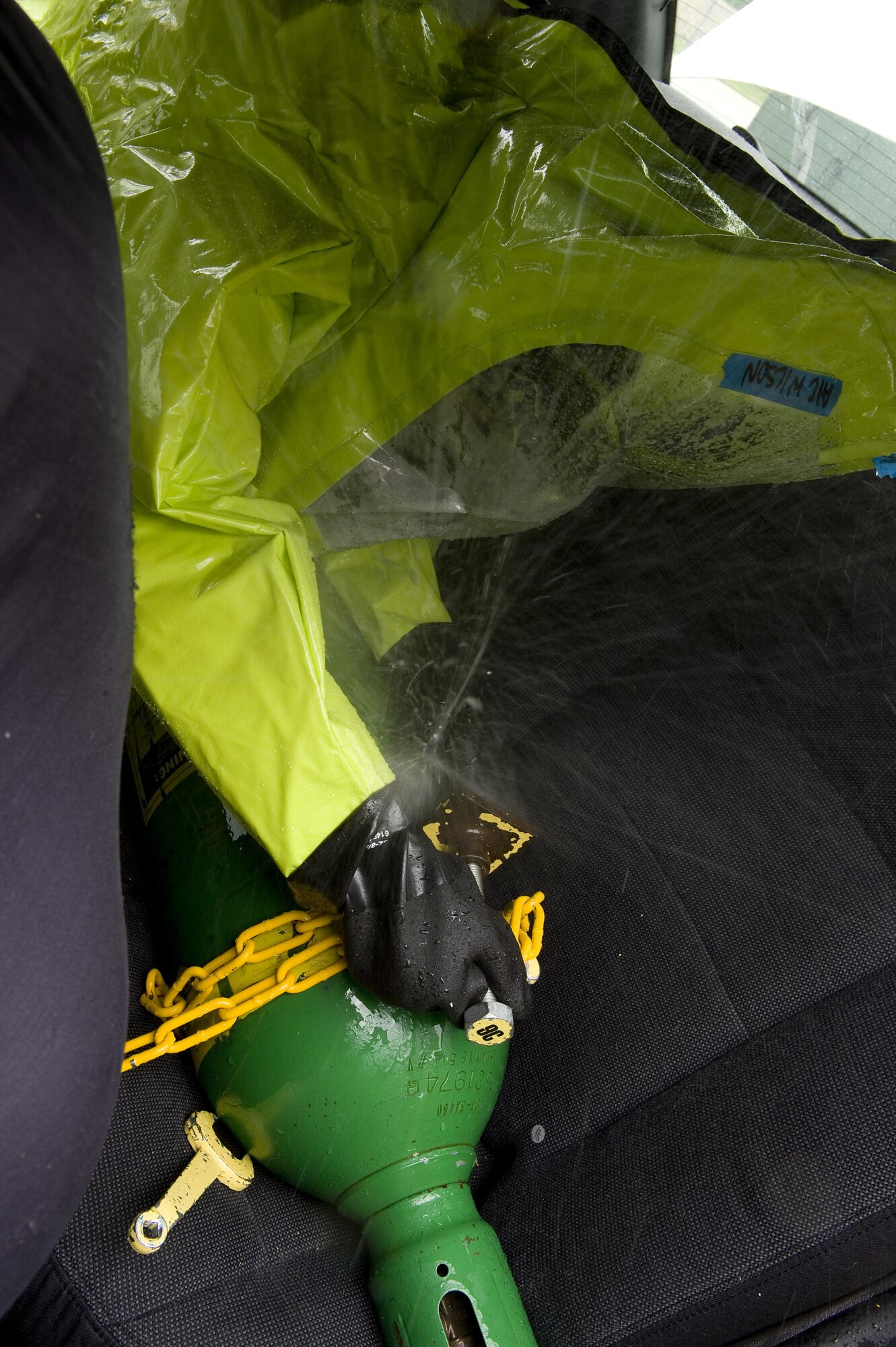 Airman 1st Class Simone Wilson, 319th Civil Engineer Squadron emergency management specialist from Grand Forks Air Force Base, North Dakota, attempts to seal a leaking cylinder during a chemical, biological, radiological, nuclear and enhanced conventional weapons training exercise at Grissom Air Reserve Base, Ind., May 19, 2015. The exercise was part of a 10-day course that allowed EM specialists from five major commands to unite and hone EM principals while incorporating combat skills and obtaining mandated recertifications. (U.S. Air Force photo/Tech. Sgt. Benjamin Mota)