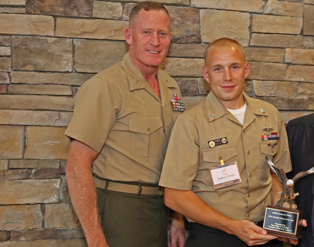 Brig. Edward D. Banta, Commanding General, Marine Corps Base Camp Pendleton, Marine Corps Installations - West, presents the Navy Enlisted father of the Year Award to Petty Officer 2nd Class Andrew B. White, a Sailor with Assault Craft Unit 5, Naval Beach Group 1, Expeditionary Strike Group 3, during a ceremony hosted by the San Diego Council, United States Navy League, at the Pacific Views Center here, June 3.

