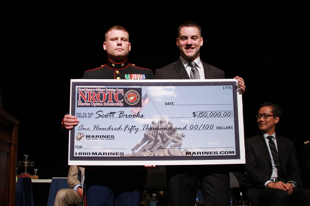 Scott Brooks, a recipient of the $150,000 Naval Reserve Officers' Training Corps scholarship poses for a photograph with U.S. Marine Corps Sgt. Glenn A. Cocagne, a canvassing recruiter with Recruiting Station Detroit and native of Erie, Michigan, during a presentation ceremony at Grosse Pointe South High School in Grosse Pointe Farms, Michigan, May 21, 2015. The NROTC scholarship is a program to educate and train qualified young men and women as commissioned officers in the Navy or Marine Corps that pays for the full cost of tuition. Brooks was one of only six students presented the award by RS Detroit. (U.S. Marine Corps photo by Cpl. J. R. Heins/Released)