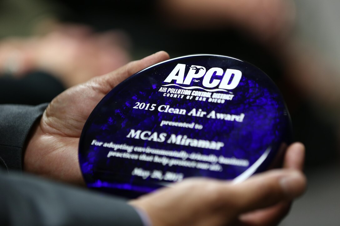 Luis Eria, a Marine Corps Air Station Miramar environmental engineer and air quality program manager, holds the Clean Air Award given to MCAS Miramar in San Diego, May 28. The San Diego County Air Pollution Control District considered several of Marine Corps Air Station Miramar’s environmental and energy programs implemented since 2010.