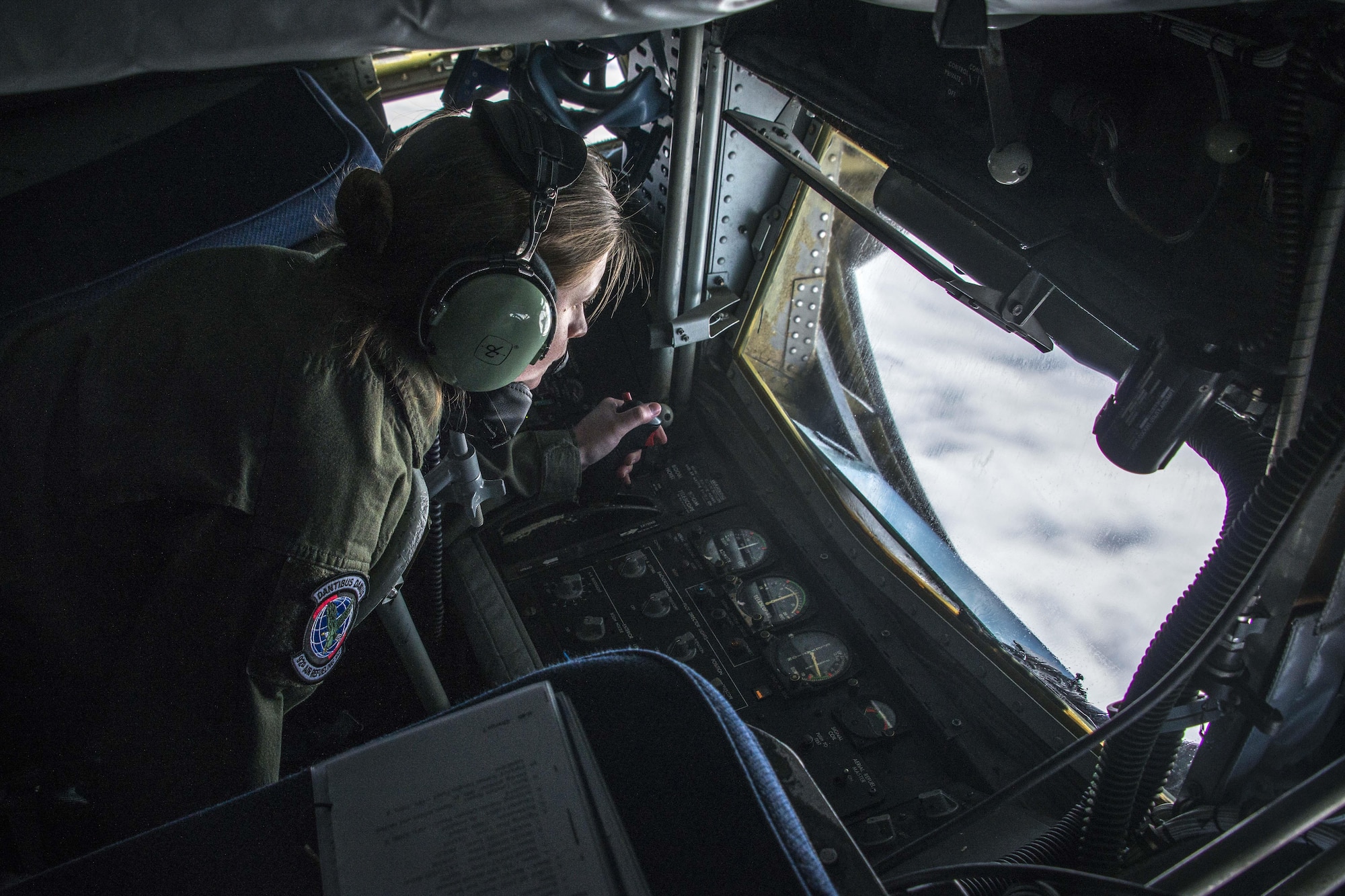 Staff Sgt. Shawna Sims connects with an F-22 Raptor fighter for aerial refueling over British Columbia, Canada, during exercise Amalgam Dart 15-2 at Eielson AFB, Alaska, May 27, 2015. The exercise spanned two forward operating locations in Canada’s Northwest Territories, two U.S. Air Force bases in Alaska, and a mobile radar site in Resolute, Nunavut, as well as the skies over much of the North American Aerospace Defense Command’s area of responsibility. Sims is a 92nd Air Refueling Squadron KC-135 Stratotanker boom operator from Fairchild Air Force Base, Wash. (U.S. Air Force photo/Staff Sgt. Benjamin W. Stratton)