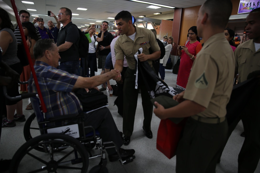Pvt. Marvin A. Rolansky, a World War II Marine veteran and Prisoner of War Medal of Honor recipient, is greeted by Sgt. Emmanuel Ortiz, an operations noncommissioned officer in charge with Marine Forces Reserve Operations, at Louis Armstrong International Airport in Kenner, La., June 3, 2015. Rolansky was captured by the Japanese after the fall of Guam on Dec. 9, 1941, and spent four years in a labor camp until his return to U.S. military control in 1945 after the end of the war. Rolansky is one of a group of WWII POWs who visited New Orleans for the American Defenders of Bataan and Corregidor Memorial Society Reunion June 2-6, 2015. 