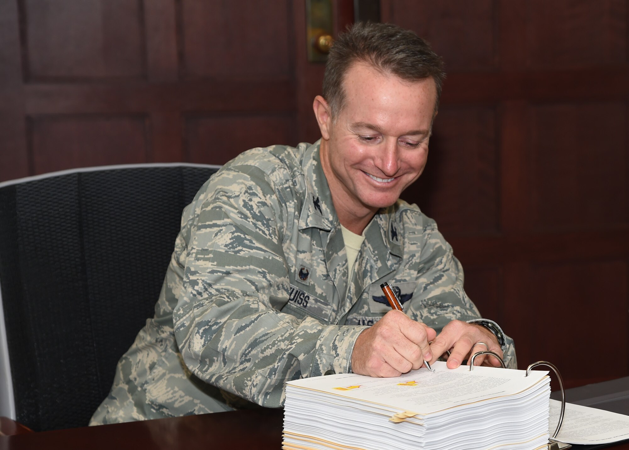 Col. Randall Huiss,15th Wing commander, signs the Joint Base Pearl Harbor-Hickam Integrated Defense Antiterrorism Plan on Joint Base Pearl Harbor-Hickam, Hawaii, June 4, 2015. The JBPHH IDAP provides requirement guidelines and procedures for implementing integrated defense and antiterrorism strategies. (U.S. Air Force photo by Tech. Sgt. Aaron Oelrich/Released)