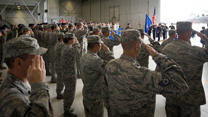 A formation of U.S. Air Force and Republic of Singapore Air Force airmen salute during the National Anthem at the beginning of the 366th Operations Group change of command ceremony at Mountain Home Air Force Base, Idaho, June 2, 2015. The 366th OG consists of three fighter squadrons, a support squadron and the Air National Guard squadron that maintains and operates the nearby range complex. (U.S. Air Force photo/Tech. Sgt. Samuel Morse)