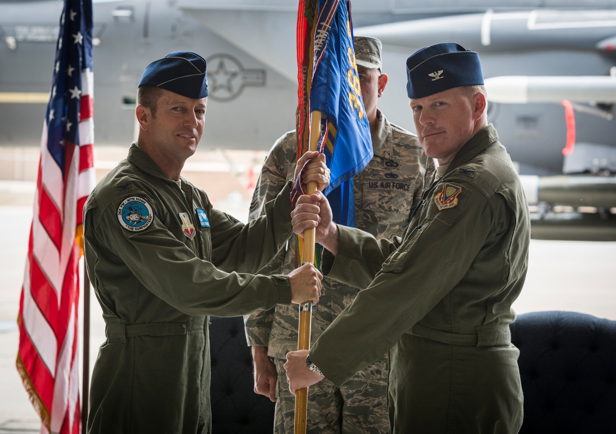 Col. David Iverson, 366th Fighter Wing commander, passes the 366th Operations Group guidon to the Group's new commander, Col. Brian McCarthy, during the 366th OG change of command ceremony at Mountain Home Air Force Base, Idaho, June 2, 2015. McCarthy served as a special assistant to the Assistant Chairman of the Joint Chiefs of Staff before being reassigned to Mountain Home AFB. (U.S. Air Force photo/Tech. Sgt. Samuel Morse)