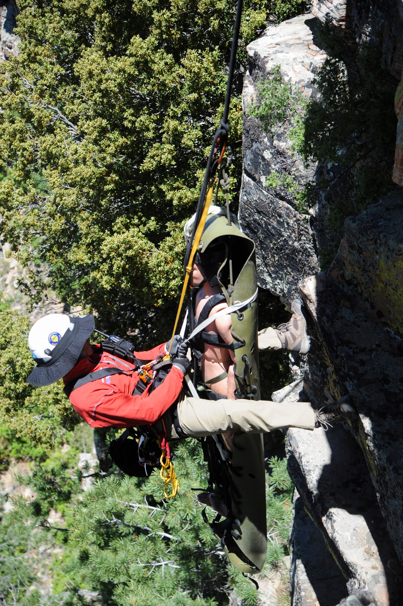 Brandon Othon, Coconino County search and rescue member, prepares to move a simulated patient up a steep cliffside during Angel Thunder 2015 high angle rescue training at Mongollon Rim, Ariz., June 3, 2015. Angel Thunder is the world’s largest personnel recovery exercise, hosting 11 partner nations and nine interagencies with a common goal to train personnel recovery forces to prepare, plan, execute and adapt for a rescue mission.  (U.S. Air Force photo by Senior Airman Betty R. Chevalier/Released)