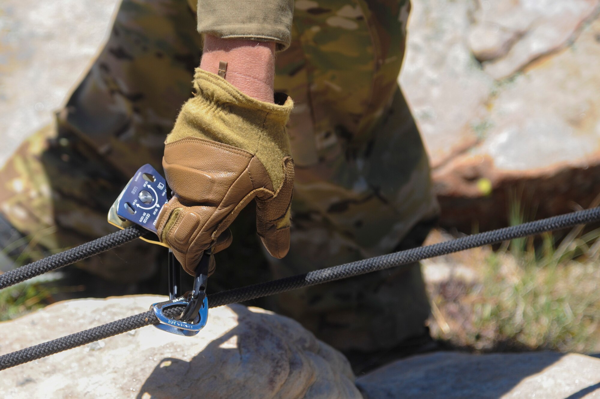 A 306th Rescue Squadron reserve pararescueman resets a pulley system used to pull a simulated patient over a steep cliffside during Angel Thunder 2015 high angle rescue training at Mongollon Rim, Ariz., June 3, 2015. Angel Thunder is the world’s largest personnel recovery exercise, hosting 11 partner nations and nine interagencies at Davis-Monthan Air Force Base, Ariz. (U.S. Air Force photo by Senior Airman Betty R. Chevalier/Released)