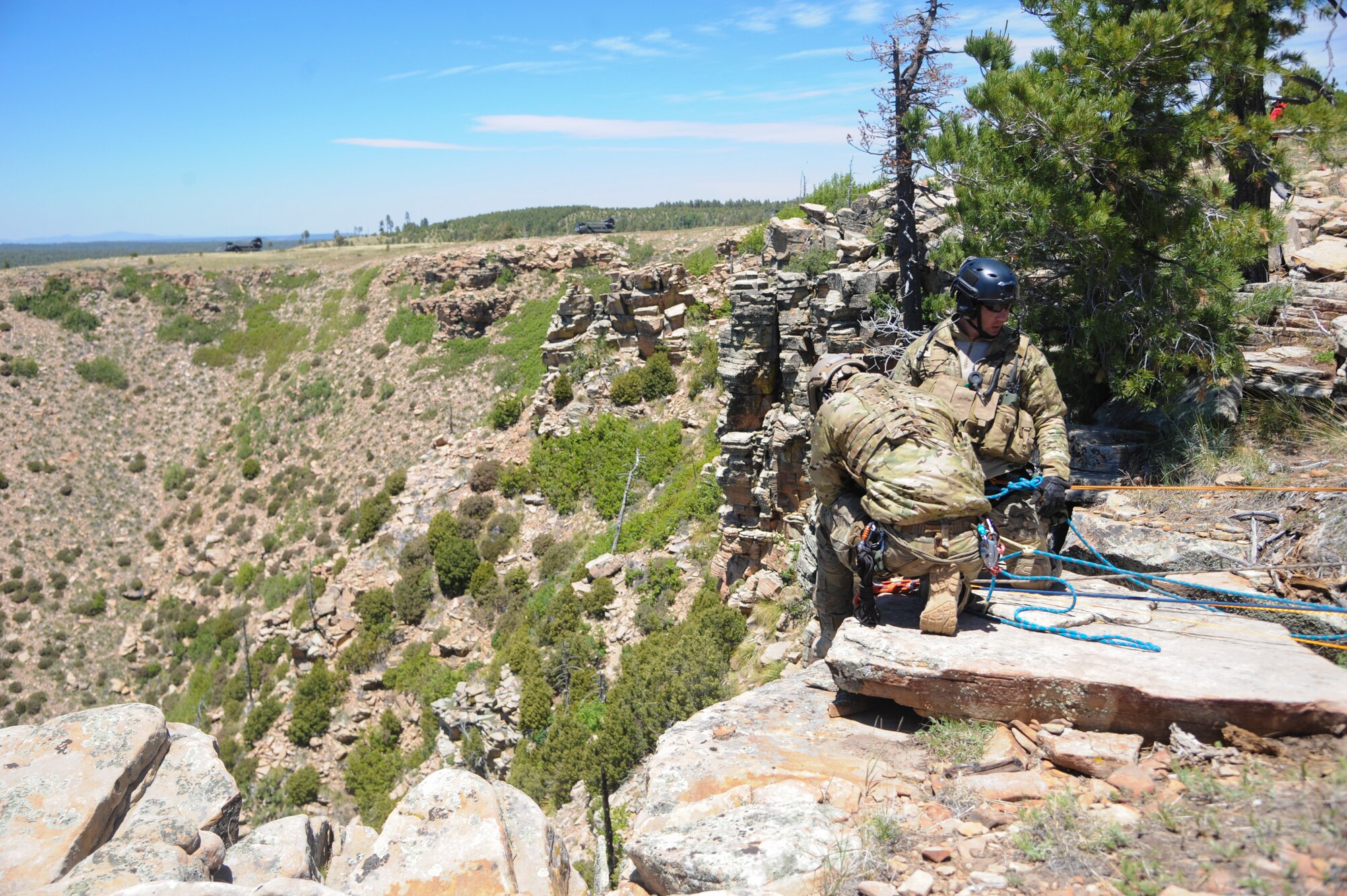 Airmen from 306th Rescue Squadron prepare to lift a simulated patient and a reserve pararescueman up a cliffside during Angel Thunder 2015 high angle rescue training at Mongollon Rim, Ariz., June 3, 2015. Angel Thunder is the largest personnel recovery exercise in the world combining joint, coalition and interagency personnel. Participants will train through the full spectrum of personnel recovery capabilities with numerous types of aircraft. (U.S. Air Force photo by Senior Airman Betty R. Chevalier/Released)