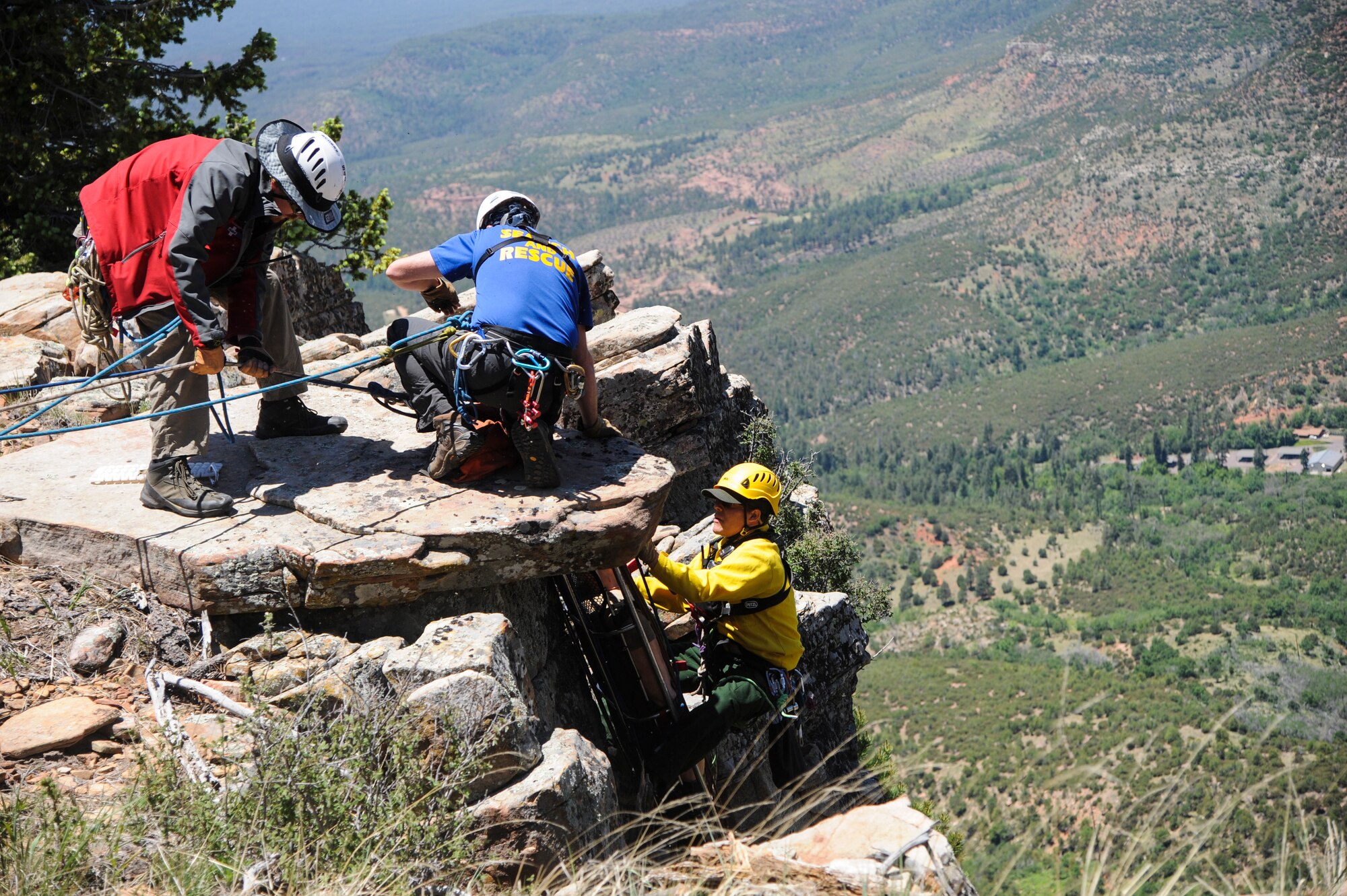 Members of several interagency search and rescue teams hoist a simulated patient up a cliffside during Angel Thunder 2015 high angle rescue training at Mongollon Rim, Ariz., June 3, 2015. Angel Thunder is the largest personnel recovery exercise in the world combining joint, coalition and interagency personnel. Participants will train through the full spectrum of personnel recovery capabilities with numerous types of aircraft. (U.S. Air Force photo by Senior Airman Betty R. Chevalier/Released)