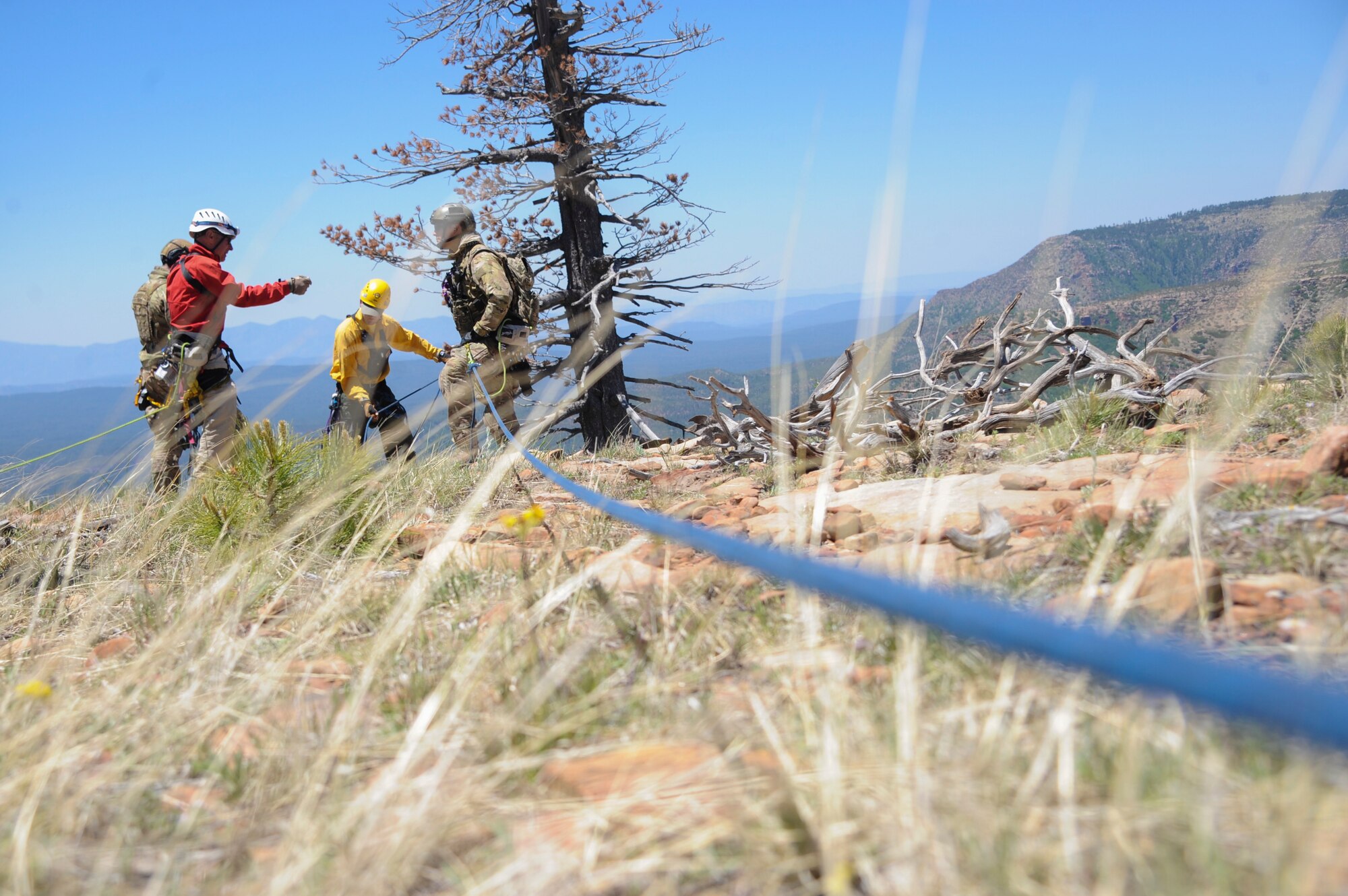 Members of several interagency search and rescue teams and 306th Rescue Squadron reserve pararescuemen discuss the assembly of an Arizona Vortex Tripod during Angel Thunder 2015 high angle rescue training at Mongollon Rim, Ariz., June 3, 2015. Angel Thunder is the world’s largest personnel recovery exercise, hosting 11 partner nations and nine interagencies with a common goal to train personnel recovery forces to prepare, plan, execute and adapt for a rescue mission.  (U.S. Air Force photo by Senior Airman Betty R. Chevalier/Released)