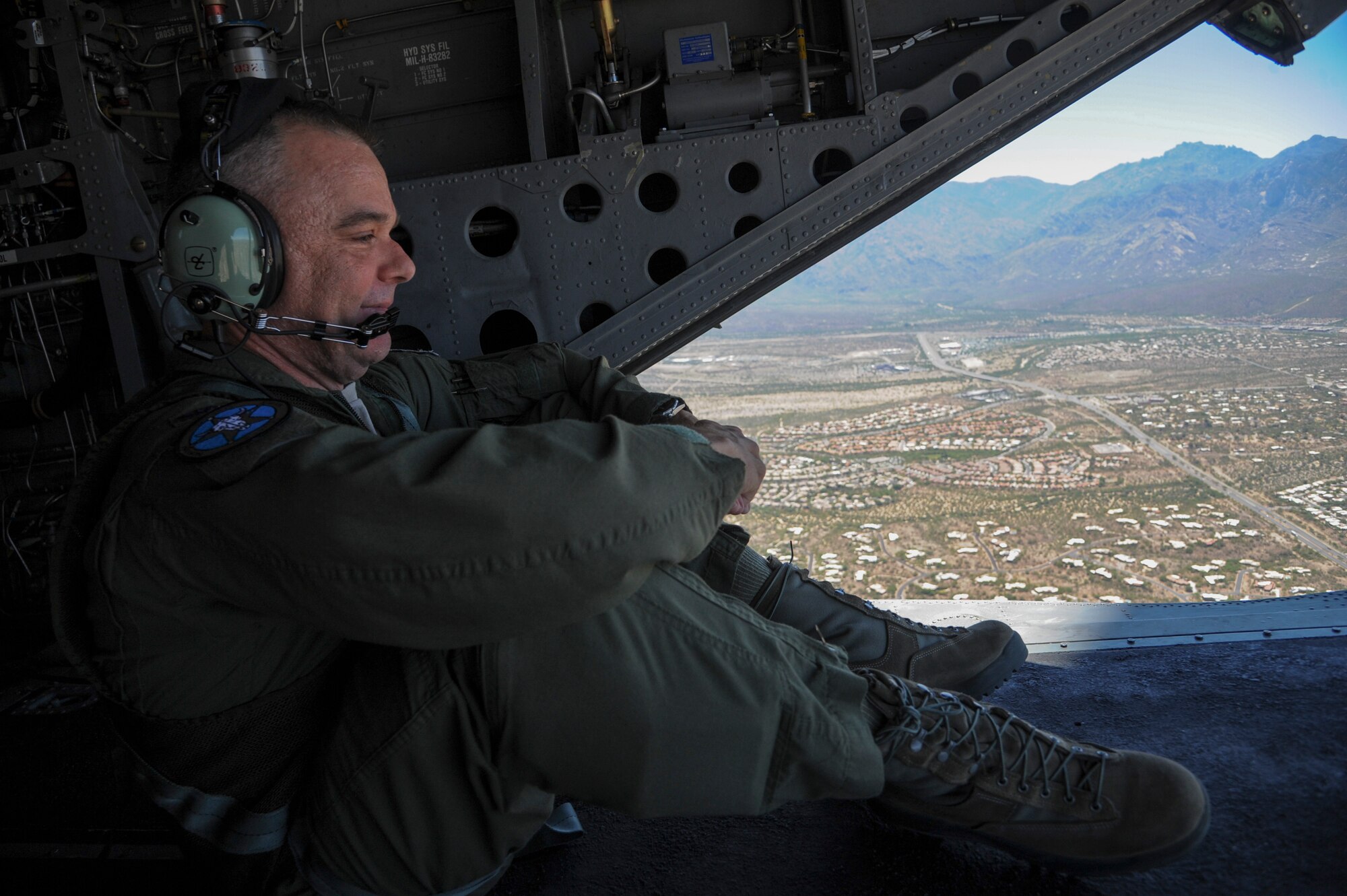 U.S. Air Force Col. Jeff Weed, 414th Combat Training Squadron commander, views Tucson, Ariz., from the ramp of a CH-47D Chinook during a flight for Angel Thunder 2015, June 3, 2015. Angel Thunder is hosted by the 355th Fighter Wing at Davis-Monthan Air Force Base, Ariz., but many flying operation will extend throughout Arizona, New Mexico and California. (U.S. Air Force photo by Senior Airman Betty R. Chevalier/Released)
