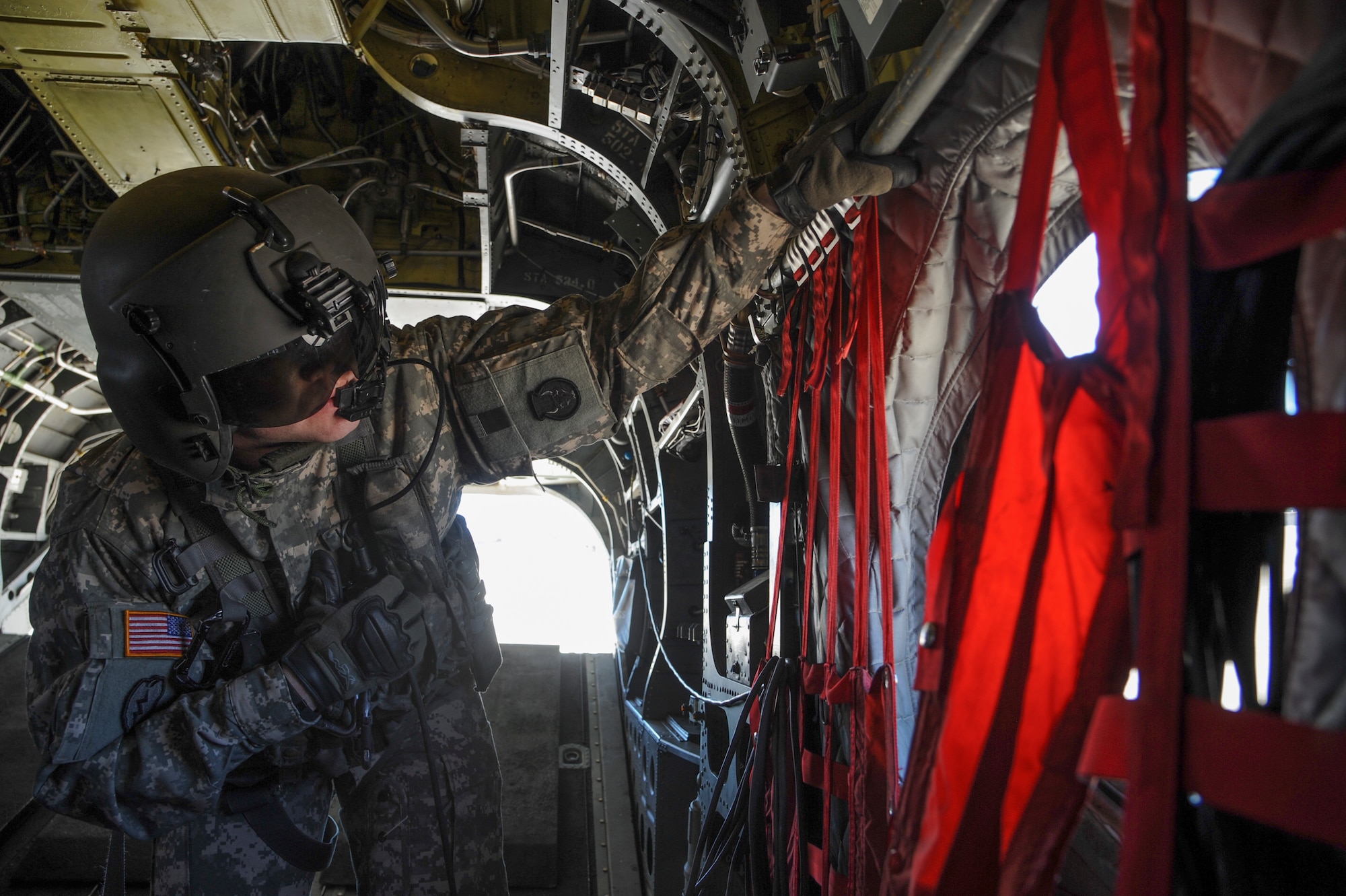 U.S. Army Staff Sgt. Wesley Vincent, Task Force Tatanka, CH-47D Chinook flight engineer, surveys the flightline before a distinguished visitor flight during Angel Thunder 2015 at Davis-Monthan Air Force Base, Ariz., June 3, 2015. Task Force Tatanka is made up of three companies from the Montana Army National Guard’s 1-189th General Support Aviation Battalion. (U.S. Air Force photo by Senior Airman Betty R. Chevalier/Released)