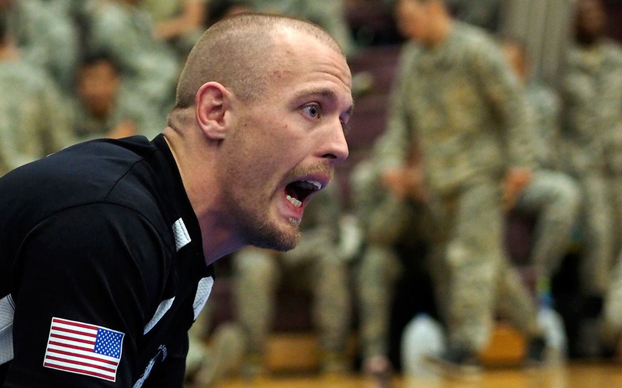 Garrett Hartley, the Brazilian jiu-jitsu coach of the combatives academy at Fort Wainwright, yells encouragement to one of his Soldiers as she competes in the tournament. (U.S. Air Force photos/Justin Connaher)
