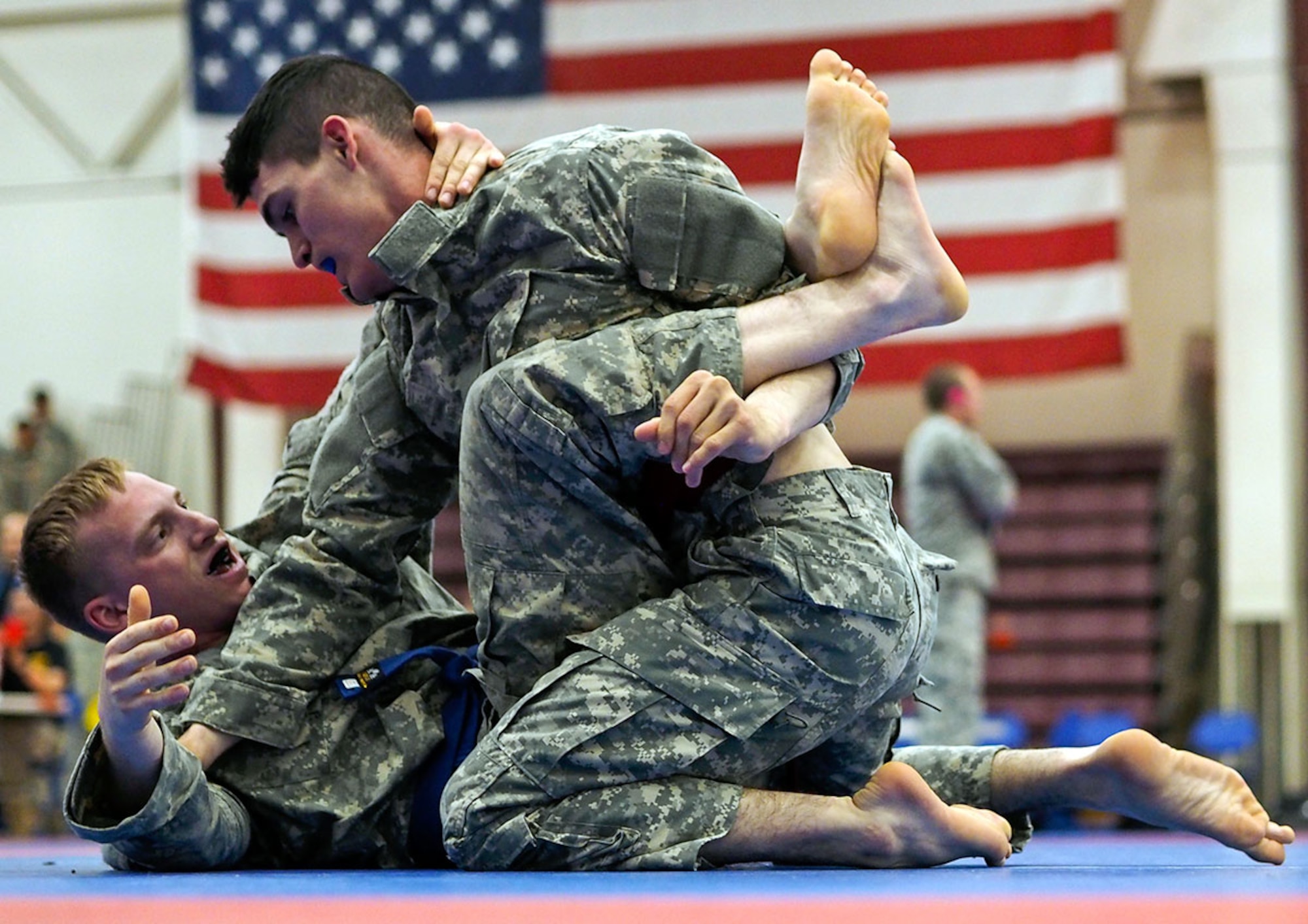 Spc. Joshua Sager, bottom, Headquarters and Headquarters Company, 3rd Battalion (Airborne), 509th Infantry Regiment, 4th Infantry Brigade Combat Team (Airborne), 25th Infantry Division, and Spc. Zakkary Cook of HHC, 17th Combat Sustainment Support Battalion, compete in the first day of the 2015 USARAK Combatives Tournament at the Buckner Physical Fitness Center on Joint Base Elmendorf-Richardson Thursday. (U.S. Air Force photos/Justin Connaher)
