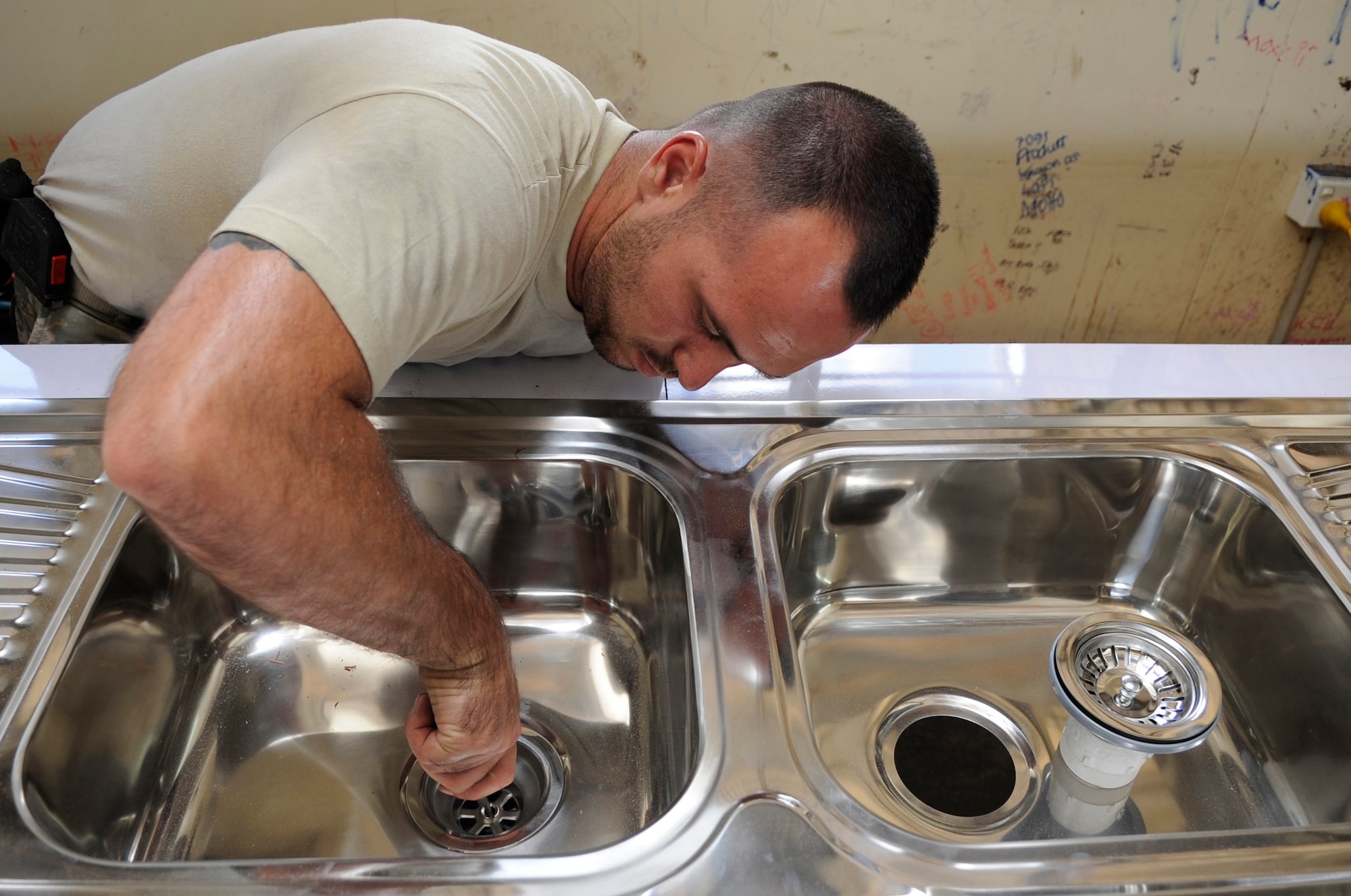U.S. Air Force Senior Airman Stephen Pond, 647th Civil Engineer Squadron plumber, Joint Base Pearl Harbor-Hickam, Hawaii, installs a sinks for a science lab at Gahuku Primary School in the Eastern Highlands Providence, Papua New Guinea, June 2, 2015. The mission of Pacific Angel is to upgrade education and health facilities, as well as work to deepen local disaster response capabilities. (U.S. Air Force photo by Staff Sgt. Marcus Morris/Released)