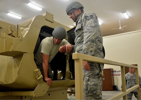 Senior Airman Jordan Fijal evacuates the Humvee simulator with assistance from Staff Sgt. John Tolerico, both from the 131st Maintenance Group, during Humvee rollover training at Camp Clark, near Nevada, Missouri, June 3, 2015.  Airmen were trained on procedures to avoid as well as team evacuation of the vehicle. 
(U.S. Air National Guard photo by Tech. Sgt. Traci Payne)
