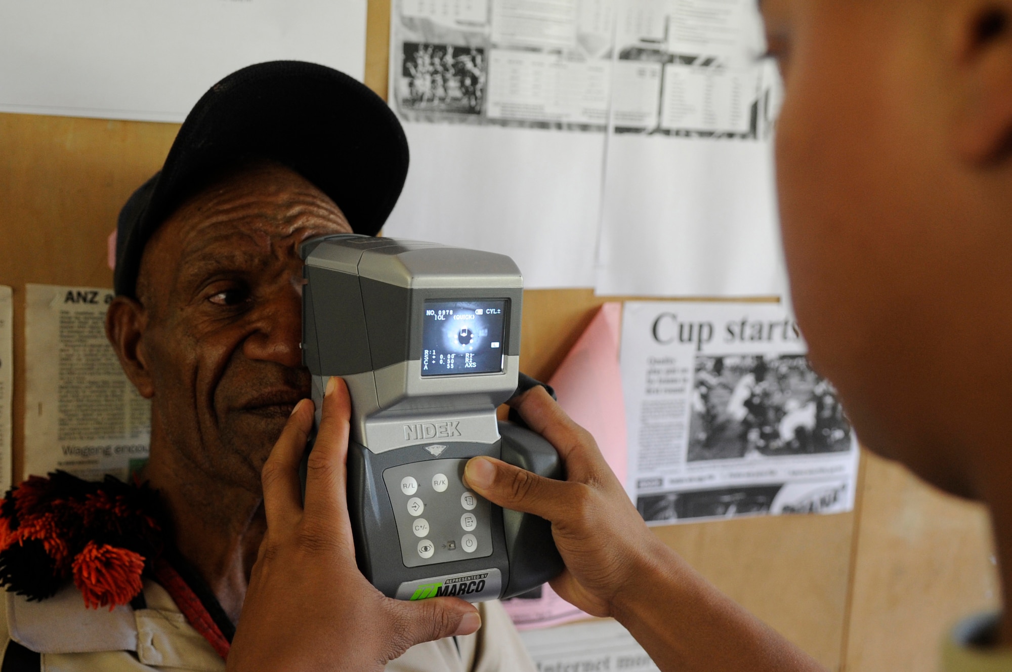 U.S. Air Force Senior Airman Randolph Callender, 36th Medical Operations Squadron optometry technician, Andersen Air Base, Guam, uses a portable autorefractor during Pacific Angel 15-4 at Unggai Primary School in Papua New Guinea, June 1, 2015. The portable autorefractor allows the optometry clinic to quickly get a baseline for a patient???s prescription glasses. The mission of Pacific Angel is to upgrade education and health facilities in the area, as well as work to deepen local disaster response capabilities.  (U.S. Air Force photo by Staff Sgt. Marcus Morris/Released)