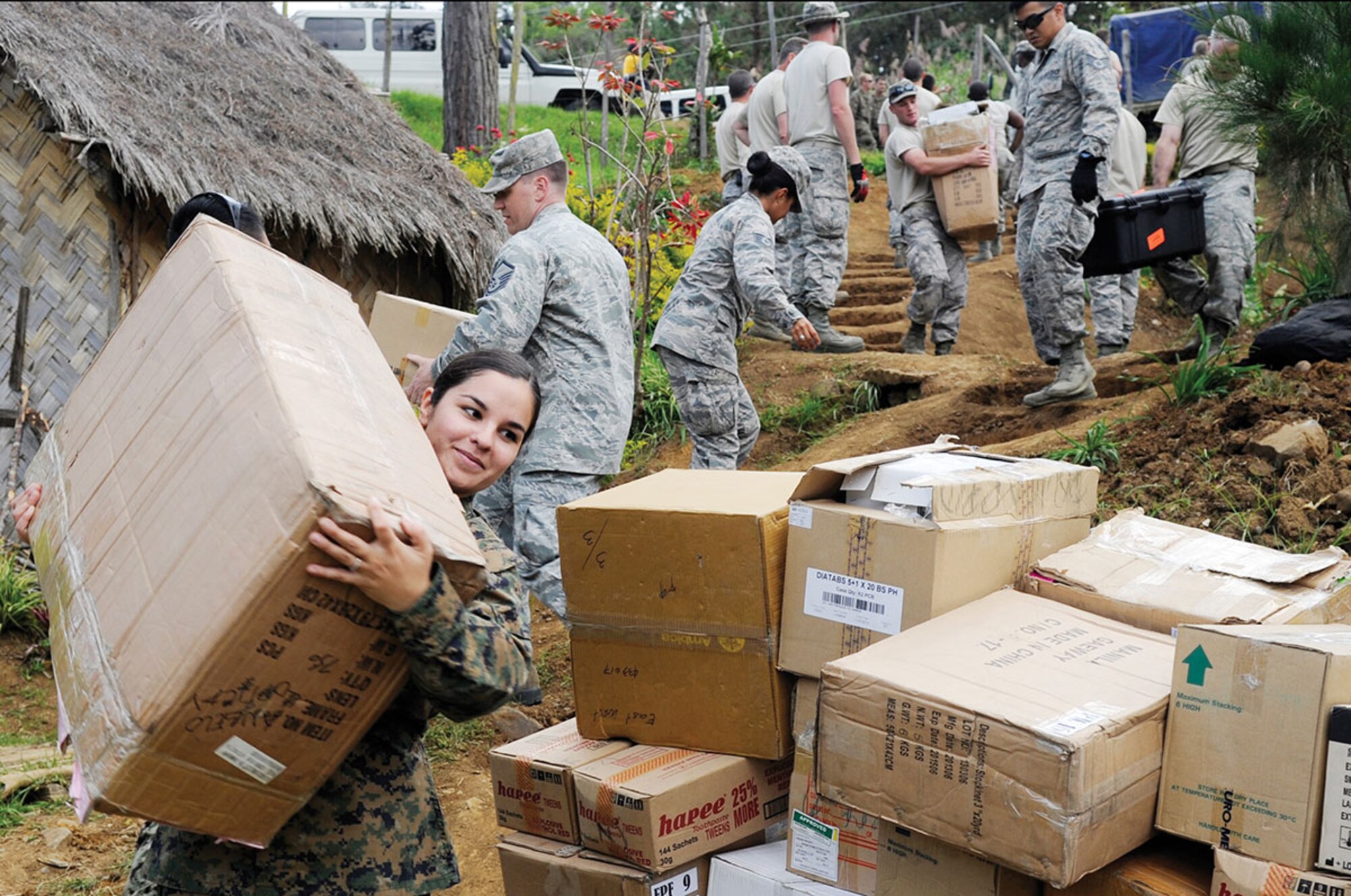 U.S. Marine Corps Hospital Corpsman Melissa Irvin, First Dental Battalion dental corpsman, from Camp Pendleton, Calif., carries a box of medical supplies to Unggai Primary School, where medical professionals set up during Pacific Angel in the Eastern Highlands of Papua New Guinea May 29. Efforts undertaken during Pacific Angel help multilateral militaries in the Pacific improve and build relationships across a wide spectrum of civic operations, which bolsters each nation’s capacity to respond and support future humanitarian assistance and disaster relief operations. (U.S. Air Force photo/ Staff Sgt. Marcus Morris)
