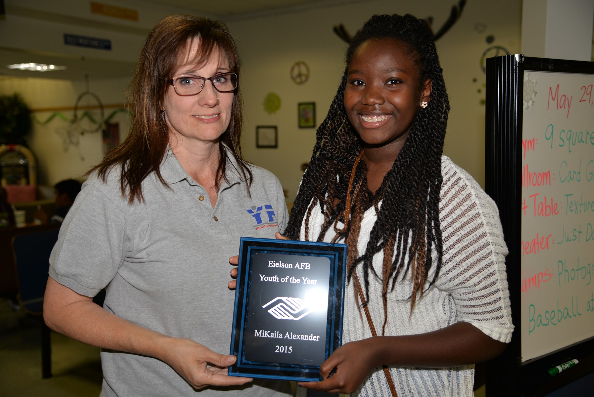 Ben Eielson High School student MiKaila Alexander receives the award for Eielson’s Military Youth of the Year from Stephanie Campiglia, the 354th Force Support Squadron Youth Center director. The teen is the daughter of retired Senior Master Sgt. Kevin B. Alexander, the 354th Force Support Squadron military support section chief, and retired Master Sgt. Lisa Alexander. (U.S. Air Force photo by Staff Sgt. Kirsten Wicker/Released)   