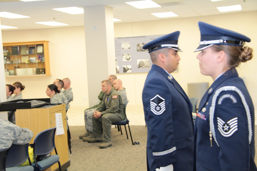 The 932nd Airlift Wing Honor Guard prepares to escort an American flag, folded and ready for a display of honor at an upcoming retirement inside the 932nd Medical Group. The group of Air Force Reserve Command reservists practice for this important additional duty to honor others for their service as they retire, and are available during unit training assembly events. (U.S. Air Force photo/Airman First Class Vincent Lang)