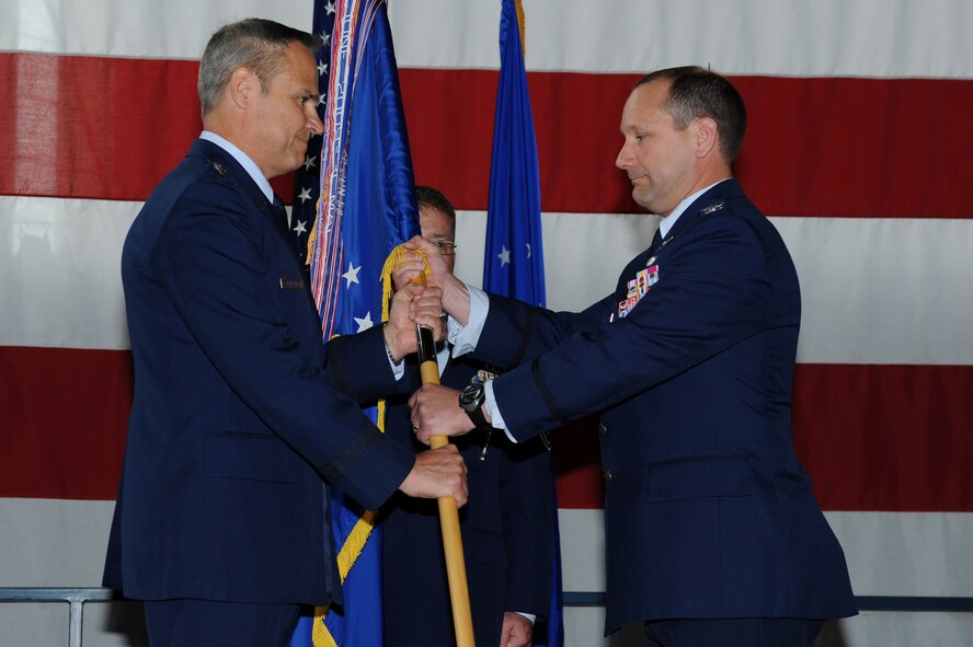 Lt. Gen. Chris Nowland, 12th Air Force and Air Forces Southern commander, transfers command of the 28th Bomb Wing to Col. Gentry Boswell at a change of command ceremony at Ellsworth Air Force Base, S.D., June 4, 2015. Boswell returned to Ellsworth after serving one year as director in the Air Force Operations Division at the Pentagon. (U.S. Air Force photo by Senior Airman Hailey R. Staker/Released)
