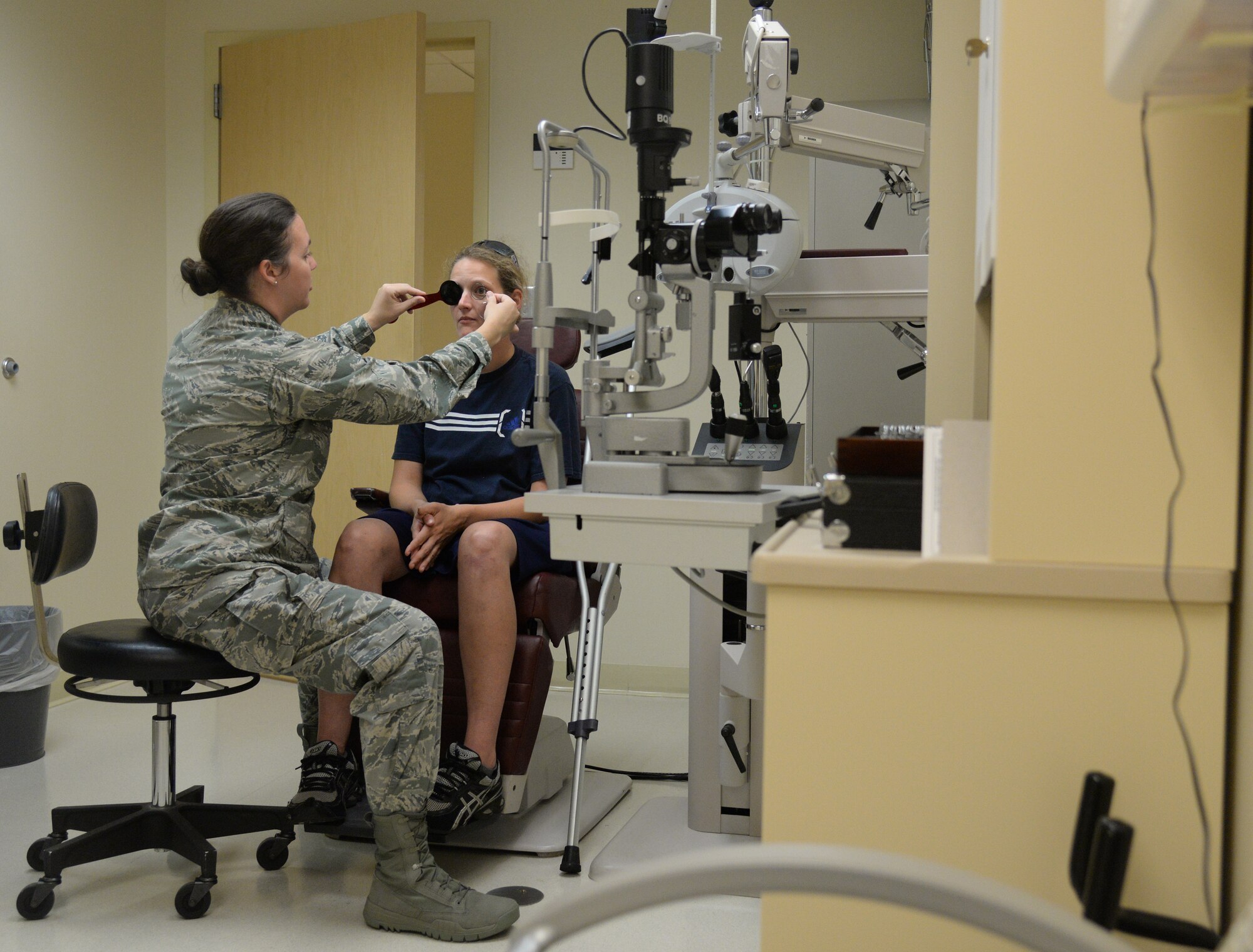 Maj. Luanne Danes, 81st Aerospace Medicine Squadron optometry flight manager, performs an annual eye exam on U.S. Navy Construction Mechanic 3rd Class Kerry O’Shea, June 2, 2015, Keesler Air Force Base, Miss. The optometry clinic offers services such as routine eye care and fittings and repair for glasses. (U.S. Air Force photo by Senior Airman Holly Mansfield)