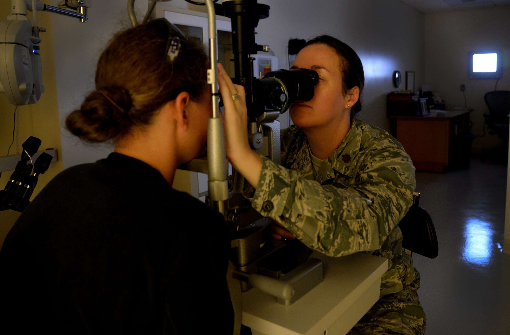 Maj. Luanne Danes, 81st Aerospace Medicine Squadron optometry flight manager, performs an annual eye exam on U.S. Navy Construction Mechanic 3rd Class Kerry O’Shea, June 2, 2015, Keesler Air Force Base, Miss. The optometry clinic offers services such as routine eye care and fittings and repair for glasses. (U.S. Air Force photo by Senior Airman Holly Mansfield)