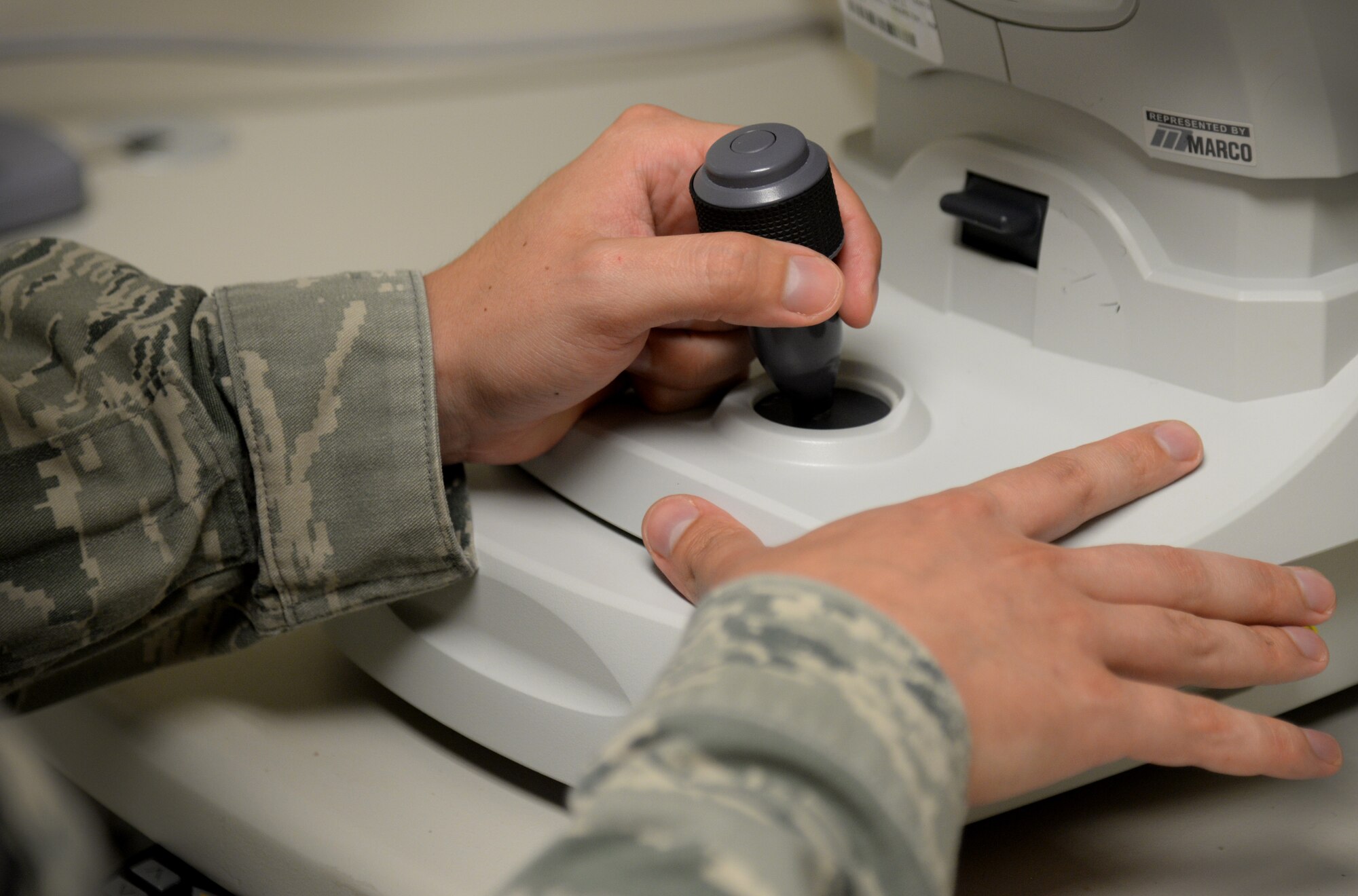 Staff Sgt. Jason Whelchel, 81st Aerospace Medicine Squadron health care manager, uses a joystick to examine a patient’s eyes, June 2, 2015, Keesler Air Force Base, Miss. The optometry clinic offers services such as routine eye care and fittings and repair for glasses. (U.S. Air Force photo by Senior Airman Holly Mansfield)