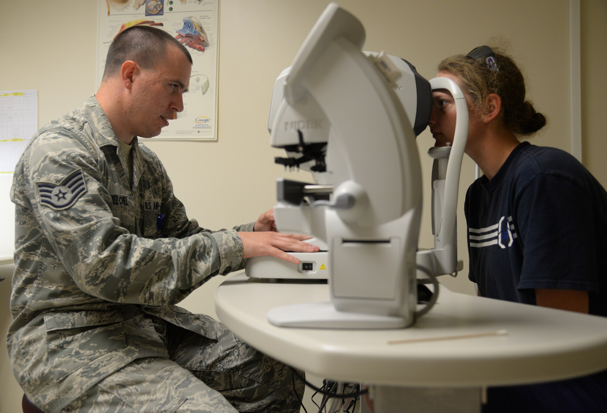 Staff Sgt. Jason Whelchel, 81st Aerospace Medicine Squadron health care manager, performs an annual eye exam on U.S. Navy Construction Mechanic 3rd Class Kerry O’Shea, June 2, 2015, Keesler Air Force Base, Miss. The optometry clinic offers services such as routine eye care and fittings and repair for glasses. (U.S. Air Force photo by Senior Airman Holly Mansfield)