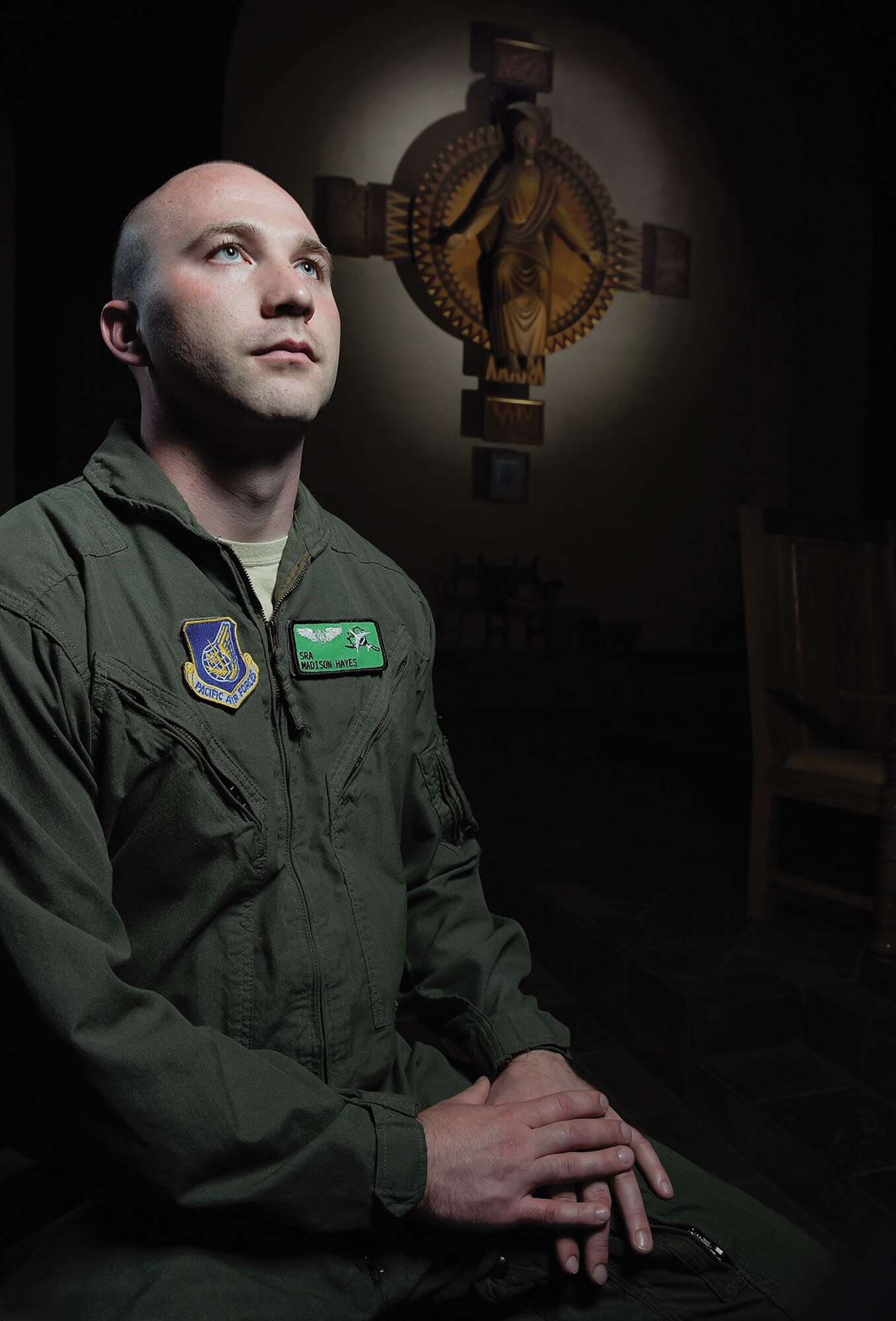 Senior Airman Madison Hayes, an airborne missions systems specialist with the 962nd Airborne Air Control Squadron, poses for a portrait at Our Lady of Guadalupe Parish in Anchorage June 2. Hayes was accepted into St. Paul Seminary School of Divinity in Minnesota and is scheduled to begin classes this fall. He will be ordained as a Catholic priest and accepted into the Archdiocese of the Military where he will serve as a Catholic chaplain to in the Air Force. (U.S. Air Force photo/Alejandro Pena)