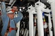 Dennis O’Dear (left) and Keith Gipson (bottom, right), both ATA outside machinists, install newly designed and fabricated flexible nozzle actuators in the Propulsion Wind Tunnel four-foot transonic wind tunnel (4T) at AEDC. The actuators are electromechanically driven ball-screw jacks which move the flexible top and bottom plates in the 4T tunnel closer together providing variable Mach numbers or wind speeds during a test. (Photo by Rick Goodfriend)