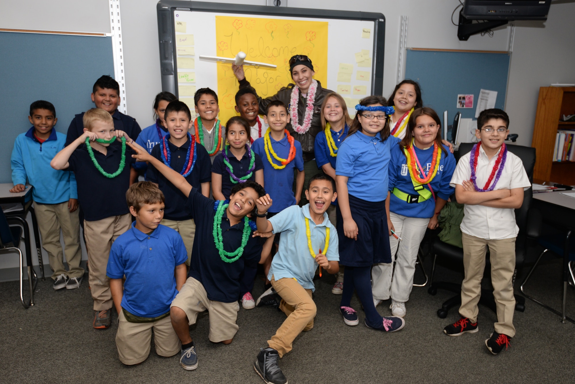 Maj. Donna Mae Williams, a pilot assigned to the 465th Air Refueling Squadron at Tinker Air Force Base, Okla., poses for a group photo with 4th grade students from Kendall-Whittier Elementary School on May 20 in Tulsa, Okla. Williams visited the students after corresponding with them about her battle with cancer and career as a pilot in the Air Force Reserve. (Air Force photo by Staff Sgt. Caleb Wanzer/Released)