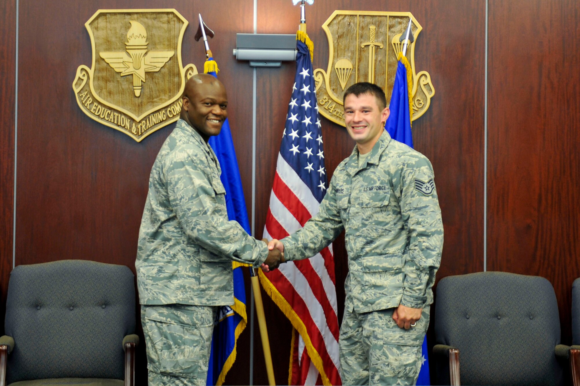 Col. Keith Green, 314th Airlift Wing vice commander, congratulates Staff Sgt.  Johnathan Sanders, a 314th Operations Group client skills technician, for his selection as Combat Airlifter of the Week June 1, 2015, at Little Rock Air Force Base, Ark.  Sanders consistently provides excellent service to the 314th Airlift Wing command staff. (U.S. Air Force photo by Senior Airman Stephanie Serrano)