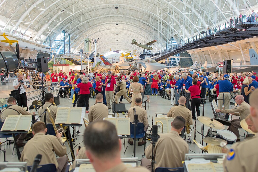 Members of a Dallas-Ft. Worth Honor Flight of World War II veterans and others  enjoy a 70th anniversary of VE Day concert at the Smithsonian's National Air  and Space Museum, Steven F. Udvar-Hazy Center. Several attendees danced while  the Airmen of Note, wearing vintage pinks and greens, played popular songs of  the World War II era. (U.S. Air Force photo by Lt. Col. Donald Schofield photo/released)