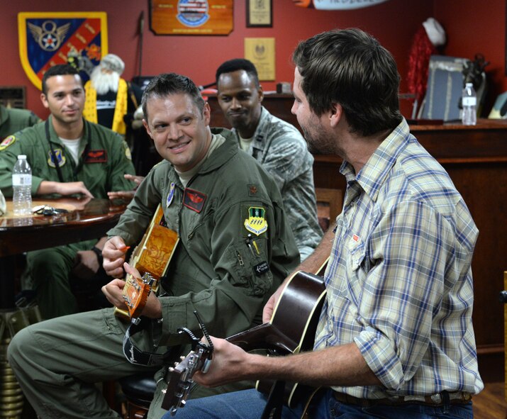 Maj. William Fish, 96th Bomb Squadron director of operations, and Ray Johnston, American 300 guest, play the song "Wagon Wheel" for Airmen of the 96th BS on Barksdale Air Force Base, Louisiana, June 2, 2015. After being diagnosed with a rare form of leukemia, a doctor once told Johnston his chances of seeing age 33 were bleak. However, having previously joined the Dallas Mavericks basketball team as a walk-on, Johnston has never been one to quit. Though cancer cut his run in the NBA short, he has defied the odds once again by turning his love for country music into a full-fledged career. (U.S. Air Force photo/Airman 1st Class Curt Beach)