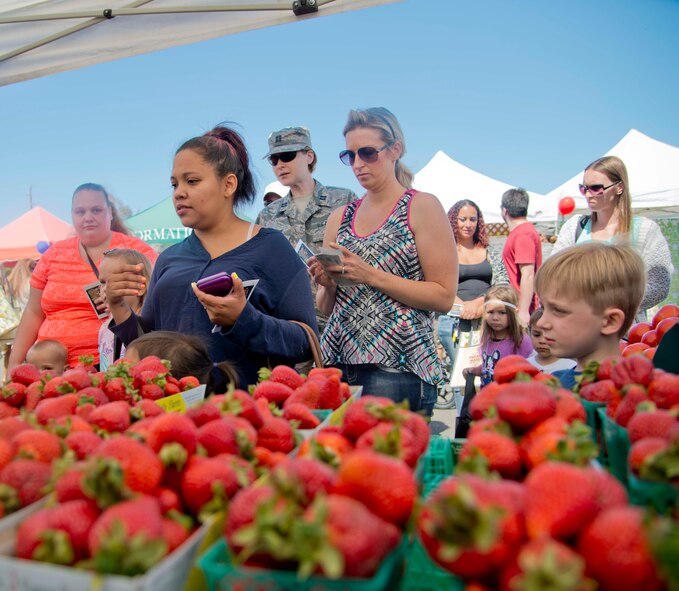 Travis Airmen and their families gather at the Travis Bowl parking lot June 2 for the first farmers market at Travis Air Force Base, California. The purpose of the farmers’ market was to bring better produce and organic produce to the base and with the farmers to help educate the base on what is good as well as organic and nonorganic foods and recipe options for them. The famers markets will run every Tuesday from 10 a.m. to 2 p.m. in June. (U.S. Air Force photo/Senior Airman Nicole Leidholm)