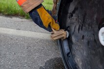 Members of the 5th Civil Engineer Squadron seal a barrel to prevent additional leakage during an exercise at Minot Air Force Base, N.D., May 29, 2015. The exercise was held to ensure first responders and base personnel are properly trained to clean up and decontaminate a simulated hazardous material situation. (U.S. Air Force photo/Airman 1st Class Christian Sullivan)