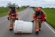 Members of the 5th Civil Engineer Squadron roll a barrel to a simulated hazardous material spill during Exercise Prairie Rampart 15-2 at Minot Air Force Base, N.D., May 29, 2015. Personnel train year-round in preparation for real-life situations. (U.S. Air Force photo/Airman 1st Class Christian Sullivan) 