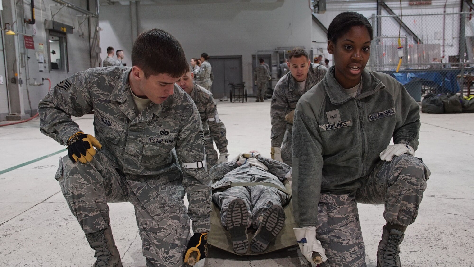 WRIGHT-PATTERSON AIR FORCE BASE, Ohio – Staff Sgt. Joseph Dunn, 445th Civil Engineer Squadron HVAC craftsman, and Senior Airman Celeste Mullings, 445th Force Support Squadron personnel apprentice, train on proper litter carrying techniques during Exercise Buckeye Storm May 2, 2015. (U.S. Air Force photo by Senior Airman Devin Long)