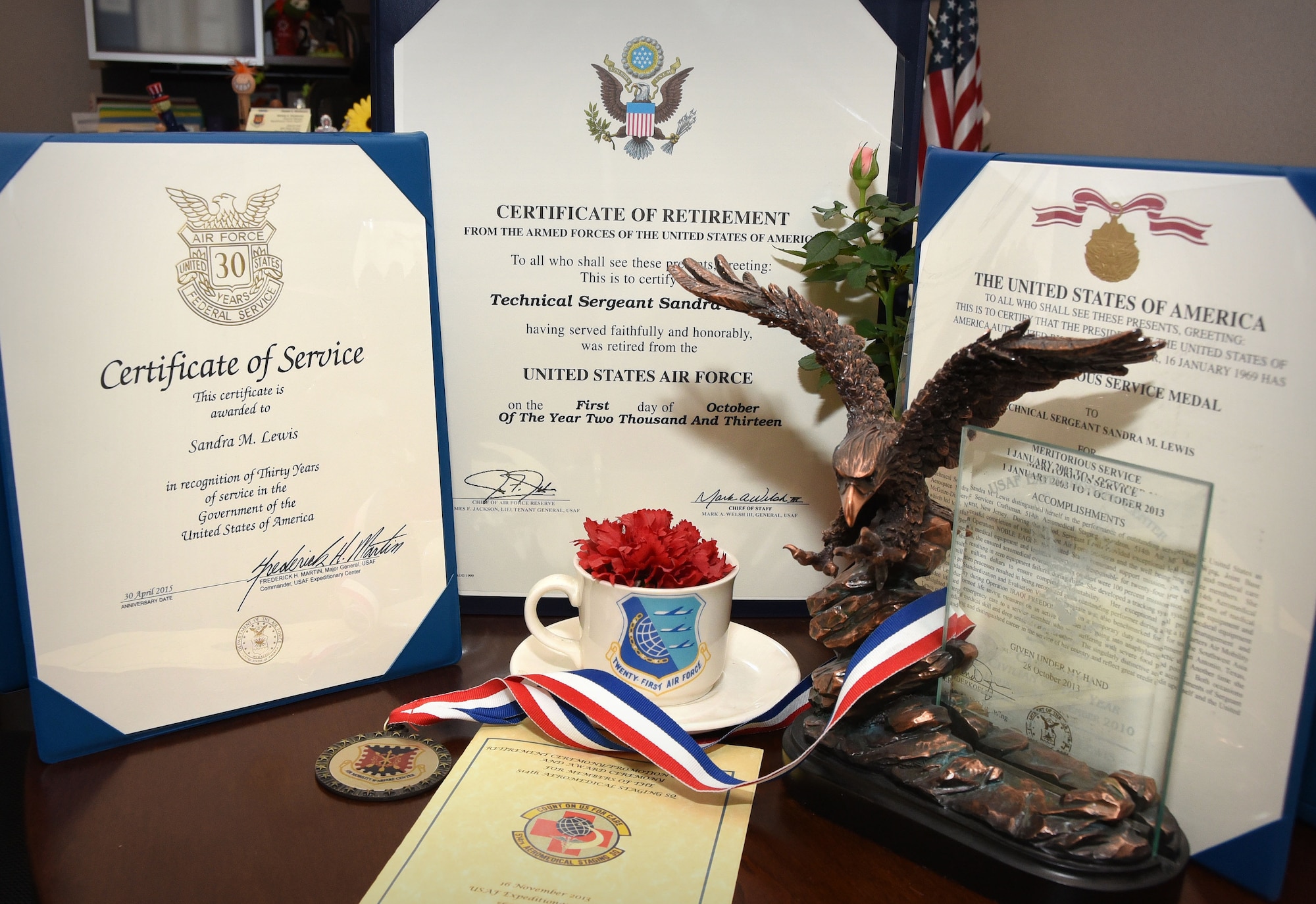 Sandy Lewis, U.S. Air Force Expeditionary Center budget technician and native of Harrisburg, Pa., recently celebrated 30 years of federal service. Displayed are a few notable awards, including the 30 years of federal service certificate and her certificate of retirement from concurrently serving in the USAF Reserves until 2013. (U.S. Air Force photo/Danielle Brooks)