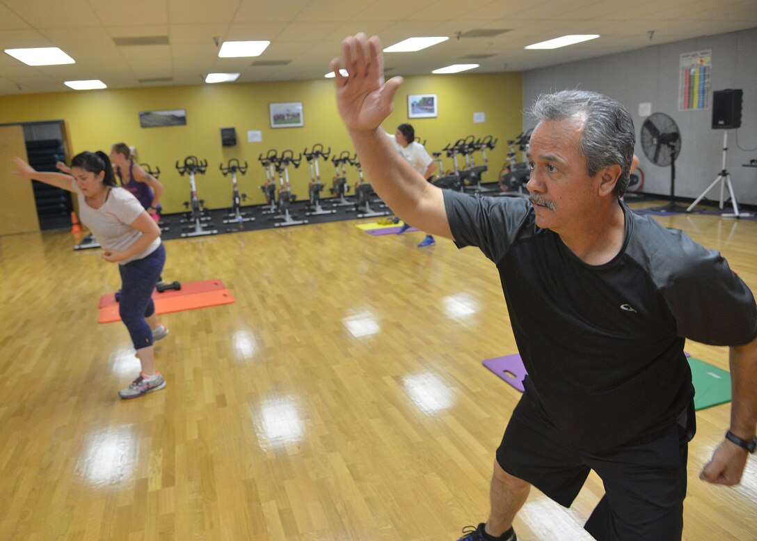 Eddie Sanillones takes part in "Basic Training," an exercise class at Kirtland's East Fitness Center. The class is taught by Audri Saylors, a certified fitness instructor, every Monday at 3 p.m. (Photo by Todd Berenger)