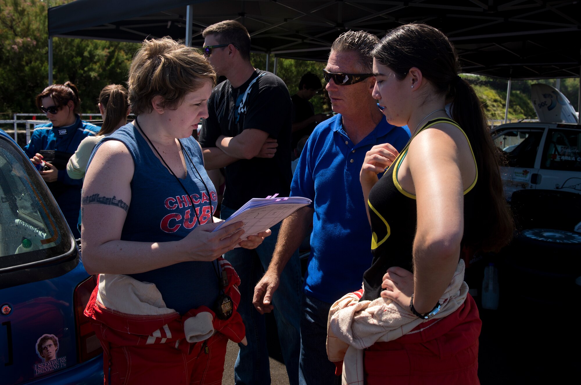 Melissa Goodnight, 65th Civil Engineer Squadron operations administrator, and Senior Airman Alanna Britton, 65th Air Base Wing general law paralegal, discuss the course with Victor Brazil during a Ladies Rally race in Vila Nova, Azores, Portugal, May 30, 2015. Britton drove the triple zero car that is designated as the safety vehicle to ensure all potential hazards on the course are reported back to racers. (U.S. Air Force photo/Tech. Sgt. Zachary Wolf)(Released)