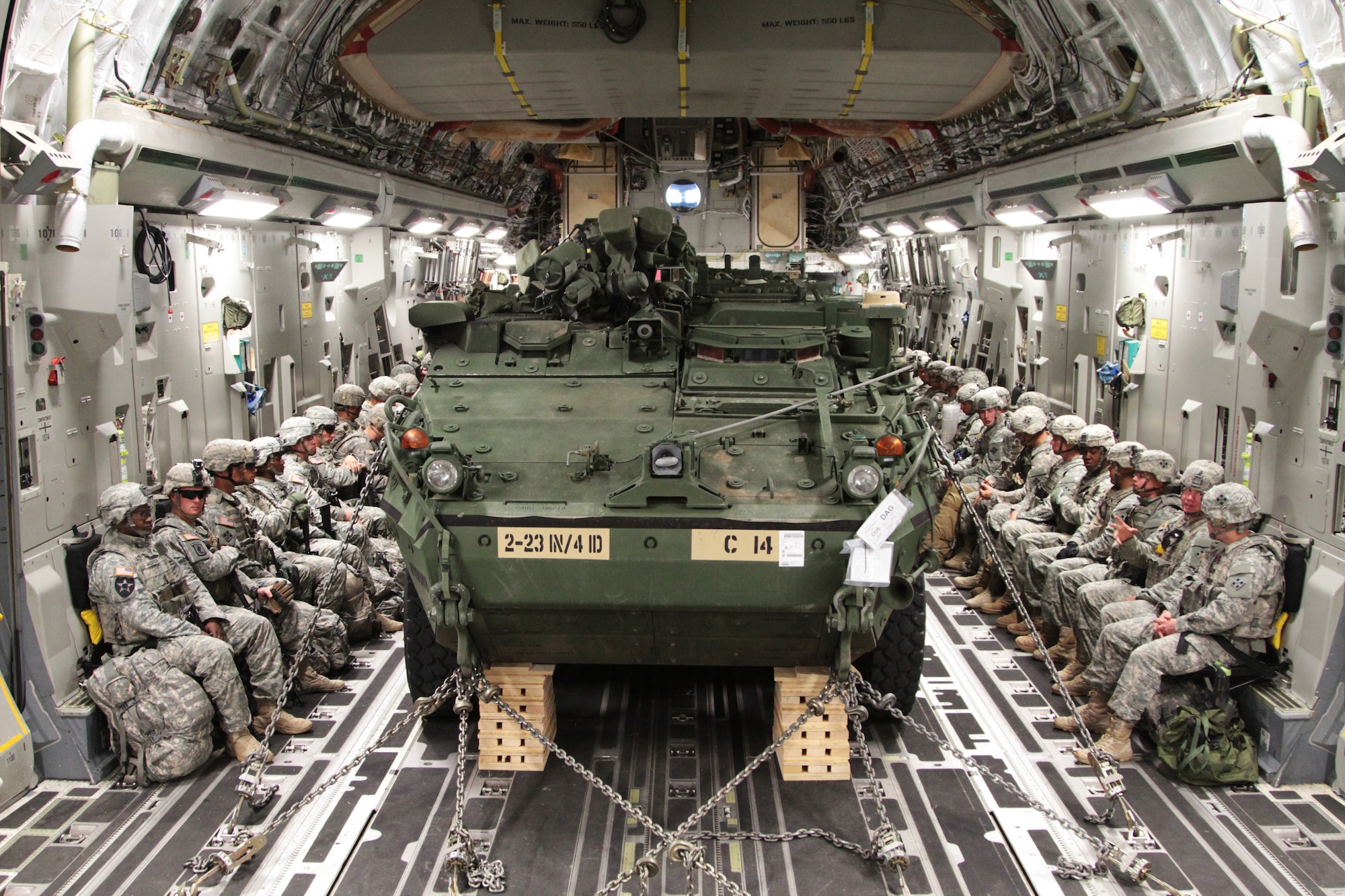 Soldiers of 2nd Battalion, 23rd Infantry Regiment, 1st Stryker Brigade Combat Team, 4th Infantry Division, prepare for their flight on a C-17 Globemaster III to the National Training Center in Fort Irwin, Calif., with their Strykers chained down in front of them, May 21, 2015.  ???It could be a very tactical high stress environment where these vehicles need to be moved into or out of at any given moment,??? said Capt. Saj El-Amin, aircraft commander/pilot, 21st Airlift Squadron. ???The capabilities of the Stryker combined with those of our jet can have a really dynamic effect on any mission.???