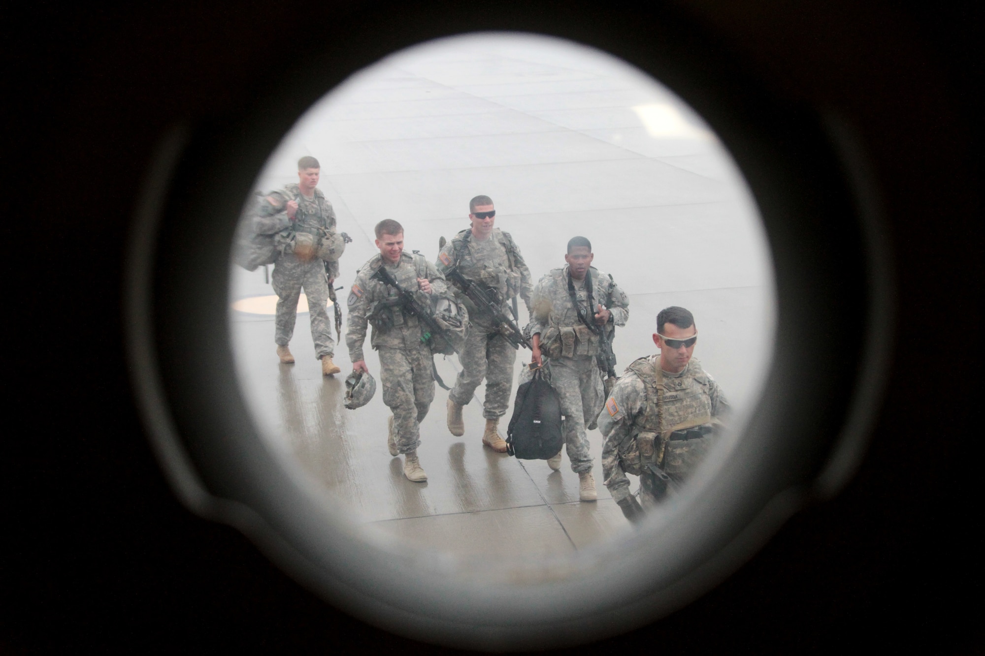 Soldiers of 2nd Battalion, 23rd Infantry Regiment, 1st Stryker Brigade Combat Team, 4th Infantry Division, line up to enter a C-17 Globemaster III in preparation for a flight to the National Training Center at Fort Irwin, Calif., May 21, 2015.  The Soldiers deployed to the major training area located in the Mojave Desert to act as the opposing force for visiting military unit training.