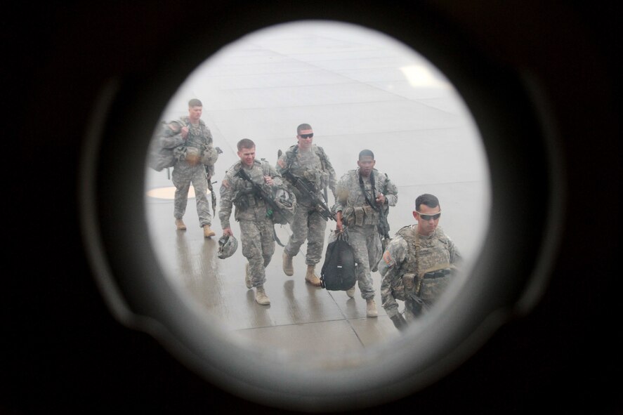 Soldiers of 2nd Battalion, 23rd Infantry Regiment, 1st Stryker Brigade Combat Team, 4th Infantry Division, line up to enter a C-17 Globemaster III in preparation for a flight to the National Training Center at Fort Irwin, Calif., May 21, 2015.  The Soldiers deployed to the major training area located in the Mojave Desert to act as the opposing force for visiting military unit training.