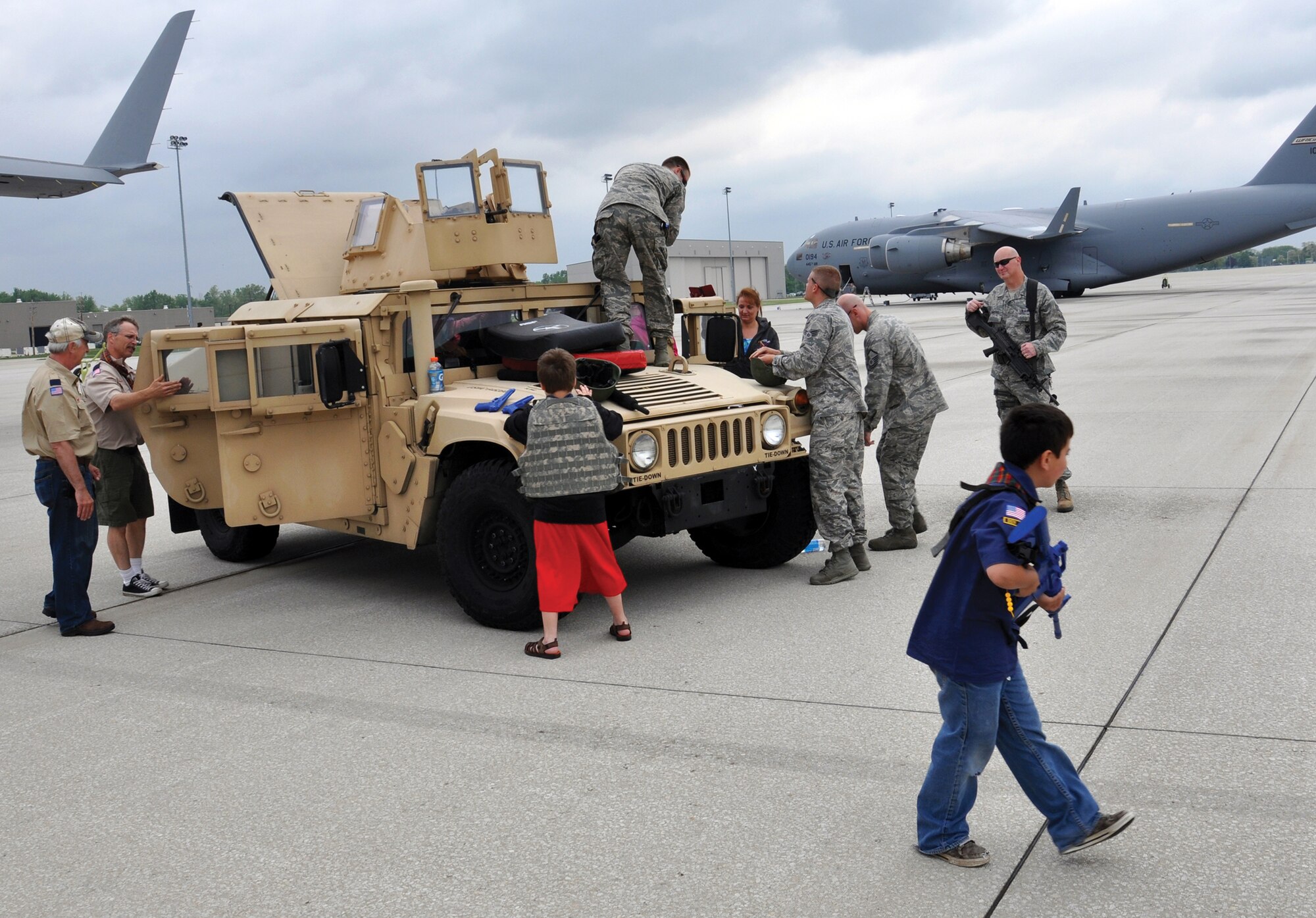 WRIGHT-PATTERSON AIR FORCE BASE, Ohio – Airmen from the 445th Security Forces Squadron allow Scouts to tour a HUMVEE and run scenarios using mock equipment during the 445th Airlift Wing Scouts Day event May 16, 2015. More than 150 Scouts signed up to attend the event. Scouts from across Ohio and Kentucky had the opportunity to not only visit with security forces but also toured a C-17 Globemaster III, participated in demonstrations by the 445th Aeromedical Evacuation Squadron and visited with firefighters from the wing while touring a fire truck. (U.S. Air Force photo/Maj. Demetrius Smith)