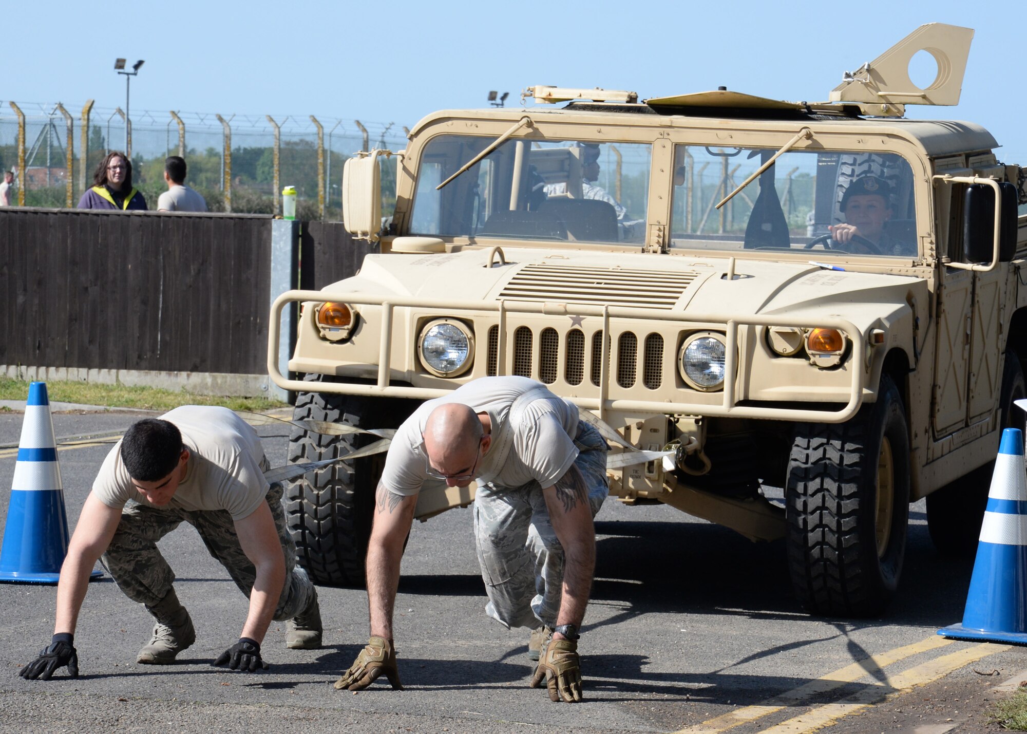 U.S. Air Force Airman 1st Class Alexander Vargas, left, 100th Security Forces Squadron response force member from Las Vegas, Nev., and U.S. Air Force Senior Airman Roehl Chapa, 100th SFS Unit Computer Information specialist from Zapata, Texas, take part in a 20 meter Humvee pull during a “Defender Challenge” May 21, 2015, on RAF Mildenhall, England. The event was designed to test teamwork and endurance while honoring fallen defenders. (U.S. Air Force photo by Gina Randall/Released)