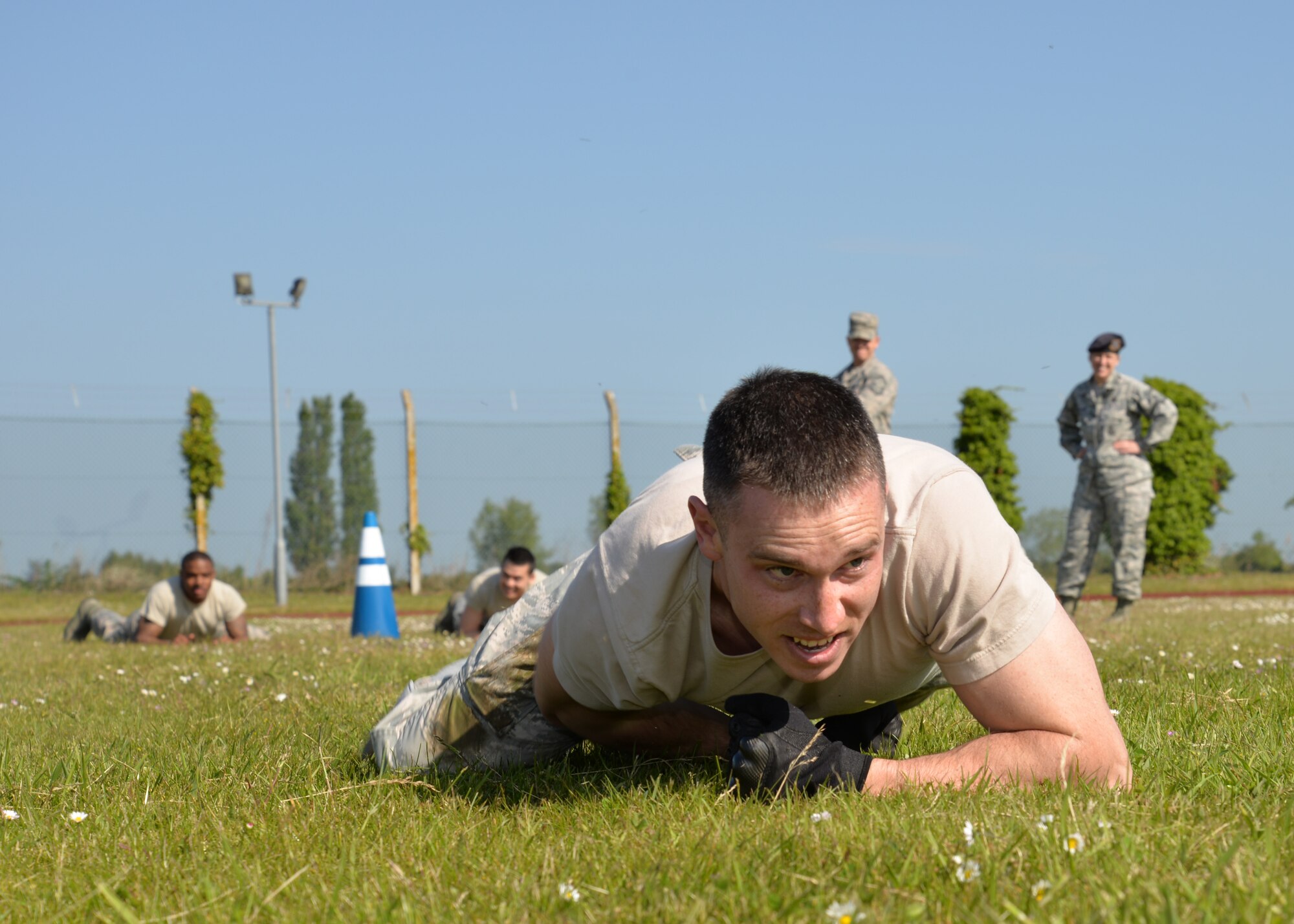 U.S. Air Force Staff Sgt. Robert Bolton, 48th Security Forces Squadron Combat Arms assistant NCO in charge from Peru, Ind., low crawls during the “Defender Challenge” event May 21, 2015, on RAF Mildenhall, England. Participants performed low-crawl as part of the joint security forces challenge with RAF Mildenhall and RAF Lakenheath defenders. (U.S. Air Force photo by Karen Abeyasekere/Released)